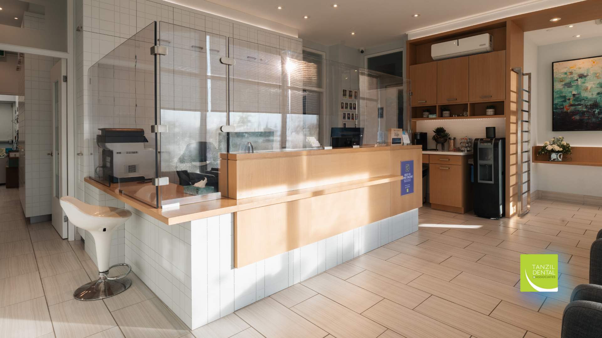 A dental office with a reception desk and a glass barrier.