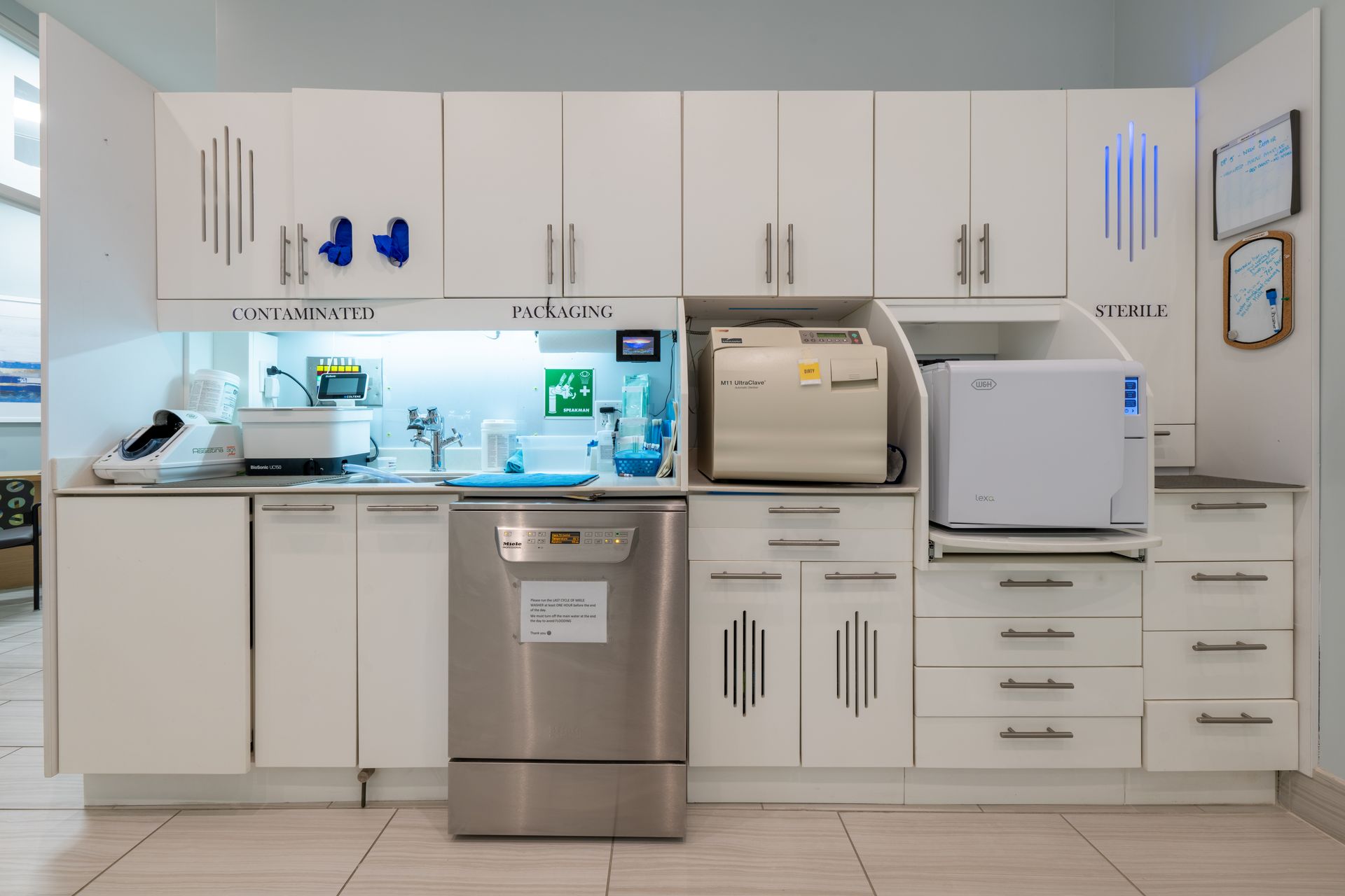 A kitchen with stainless steel appliances and white cabinets.
