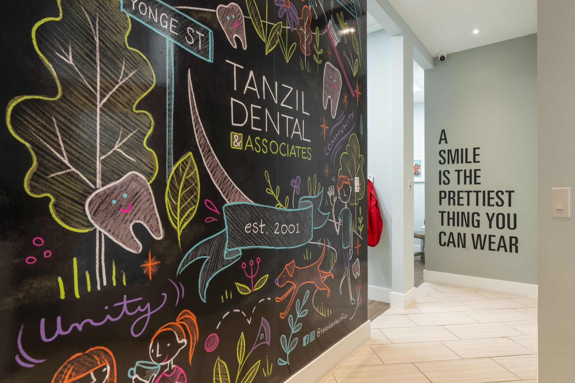 Tanzil dental associates has a chalkboard wall that says a smile is the prettiest thing you can wear