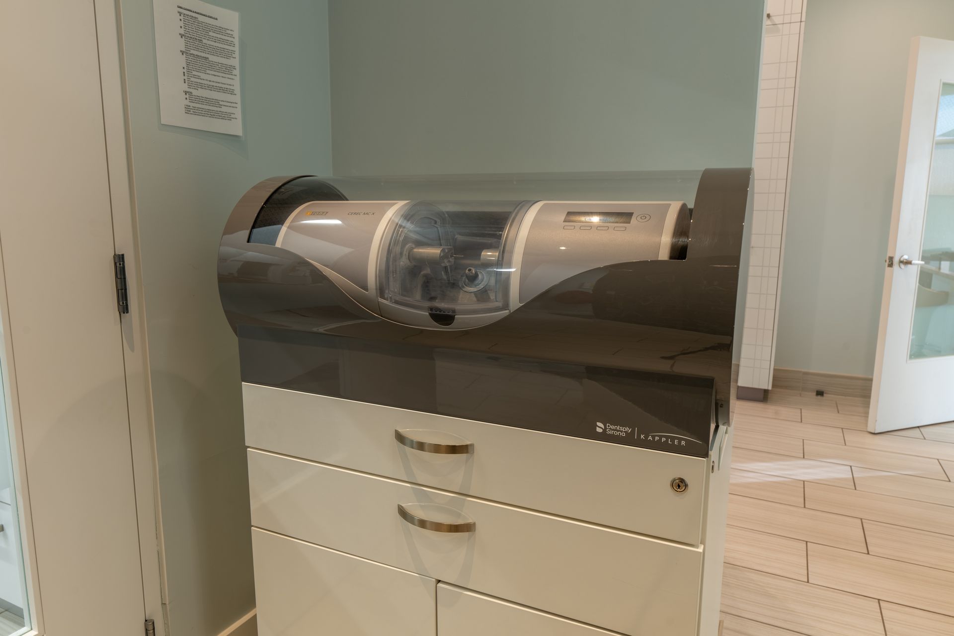 A machine is sitting on top of a dresser in a room.