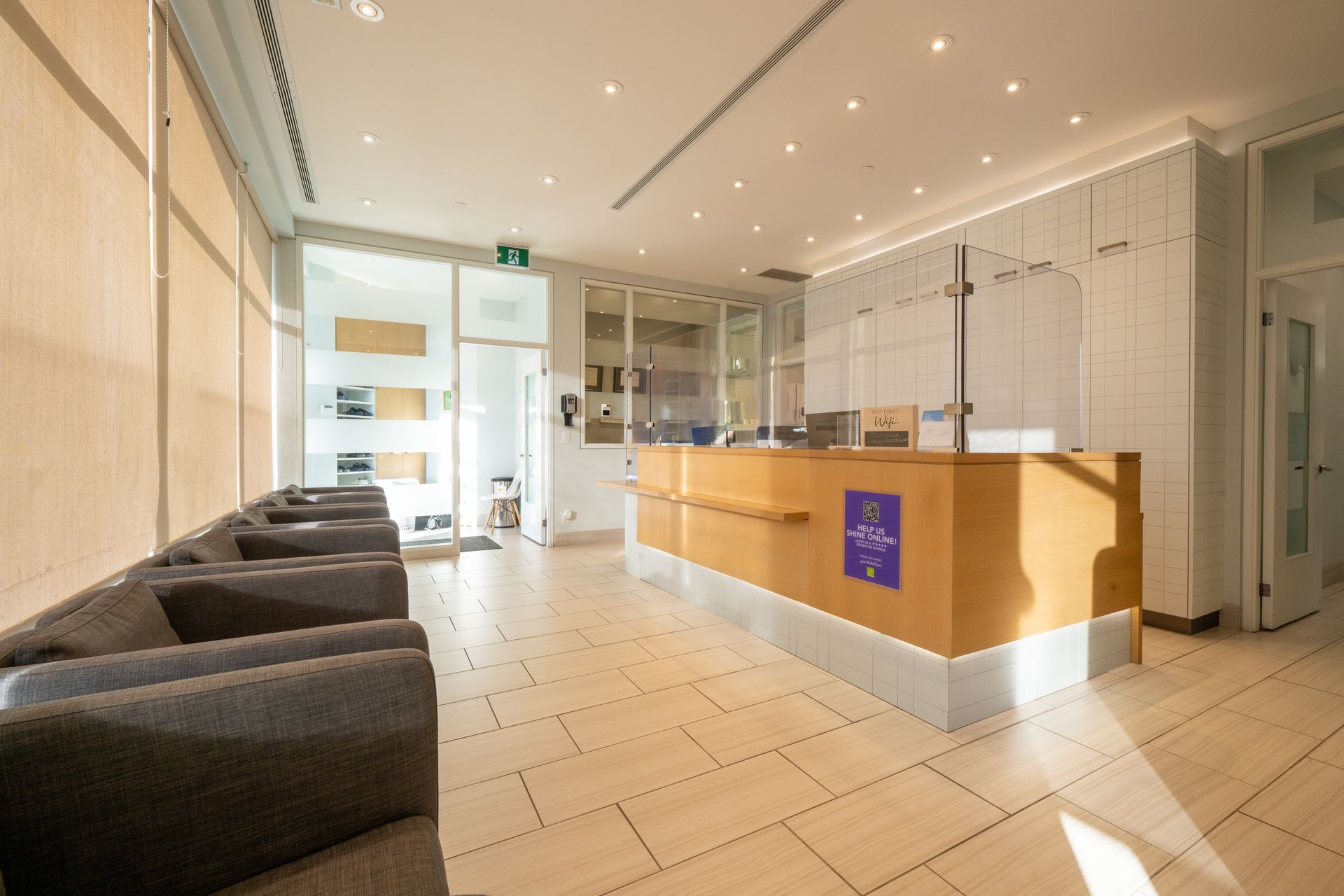 A waiting room with chairs and a counter in a hospital.