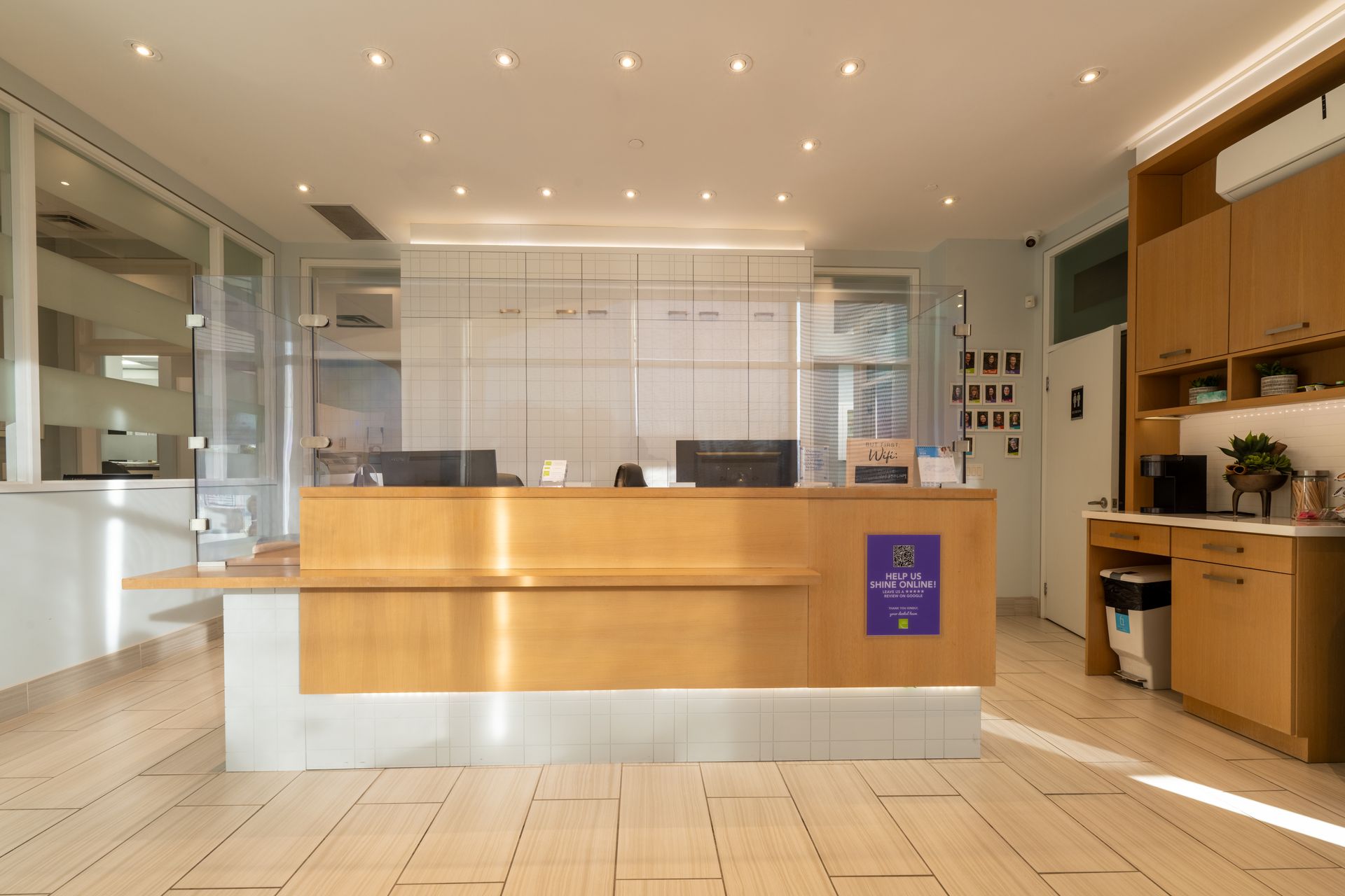 A reception desk in a hospital with a purple sign on it.