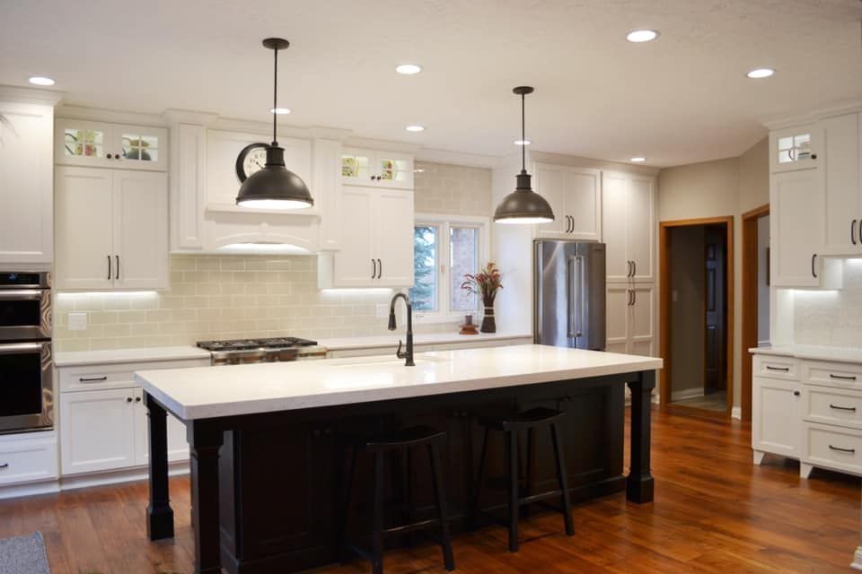 Complete kitchen electrical installation with pendant lights and recessed lighting over island