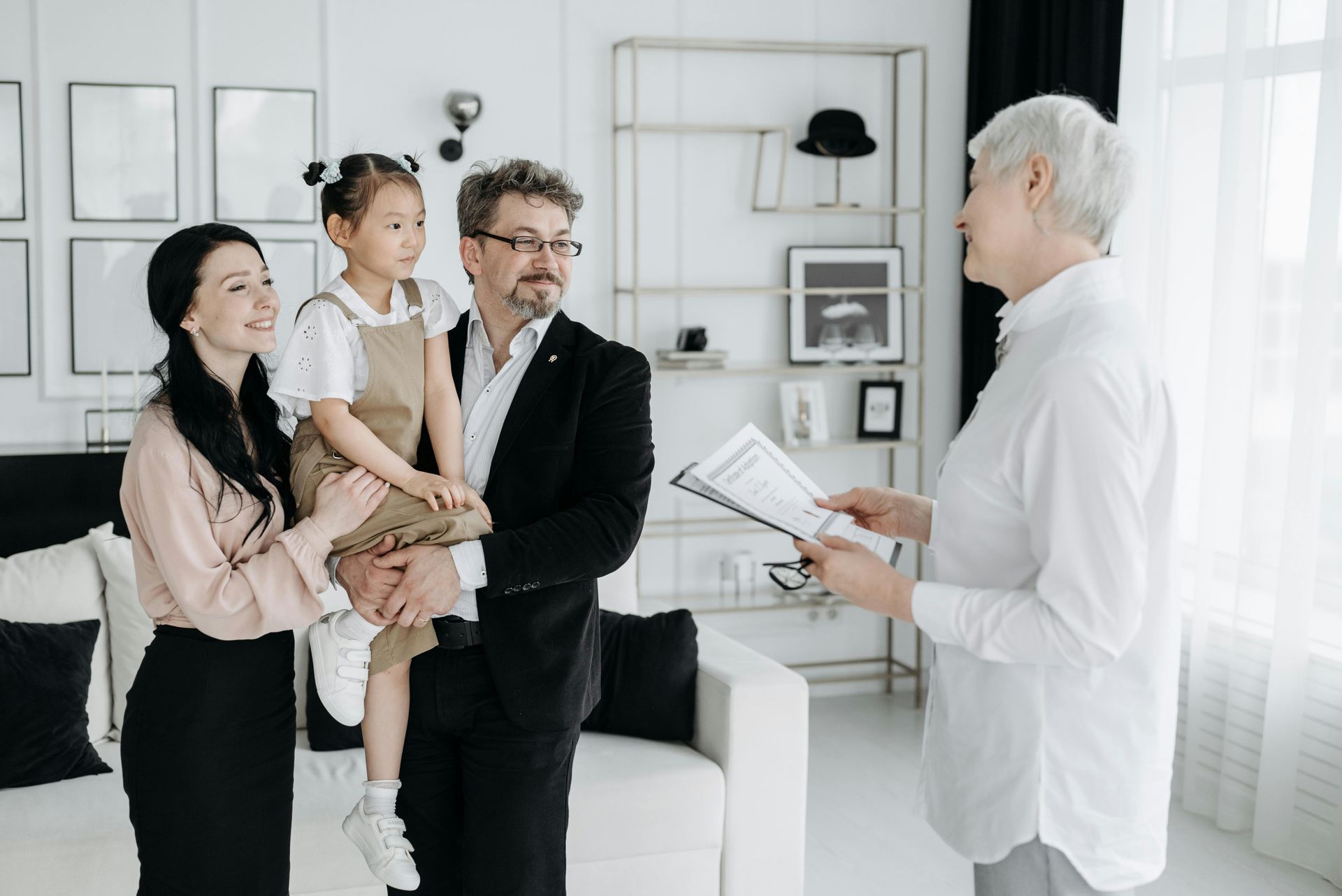 Family speaking with a doctor in a bright clinic waiting room