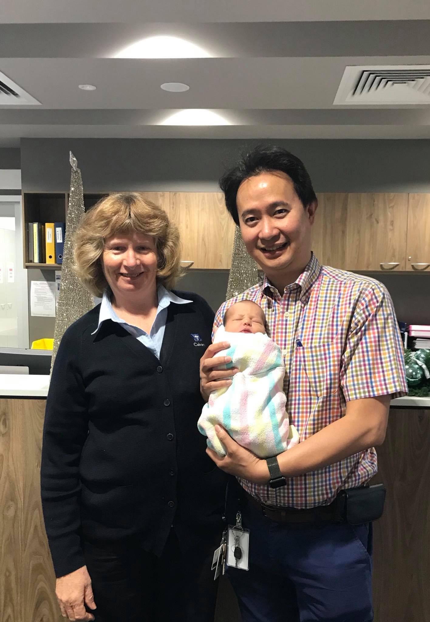Dr. Tam Carrying A Baby — Bruce ACT — Dr. Sim Hom Tam