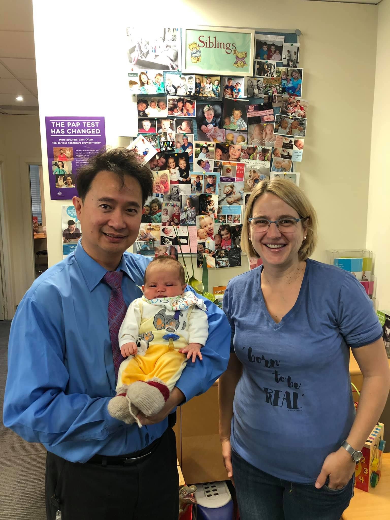Dr. Tam Holding And A Mother — Bruce ACT — Dr. Sim Hom Tam
