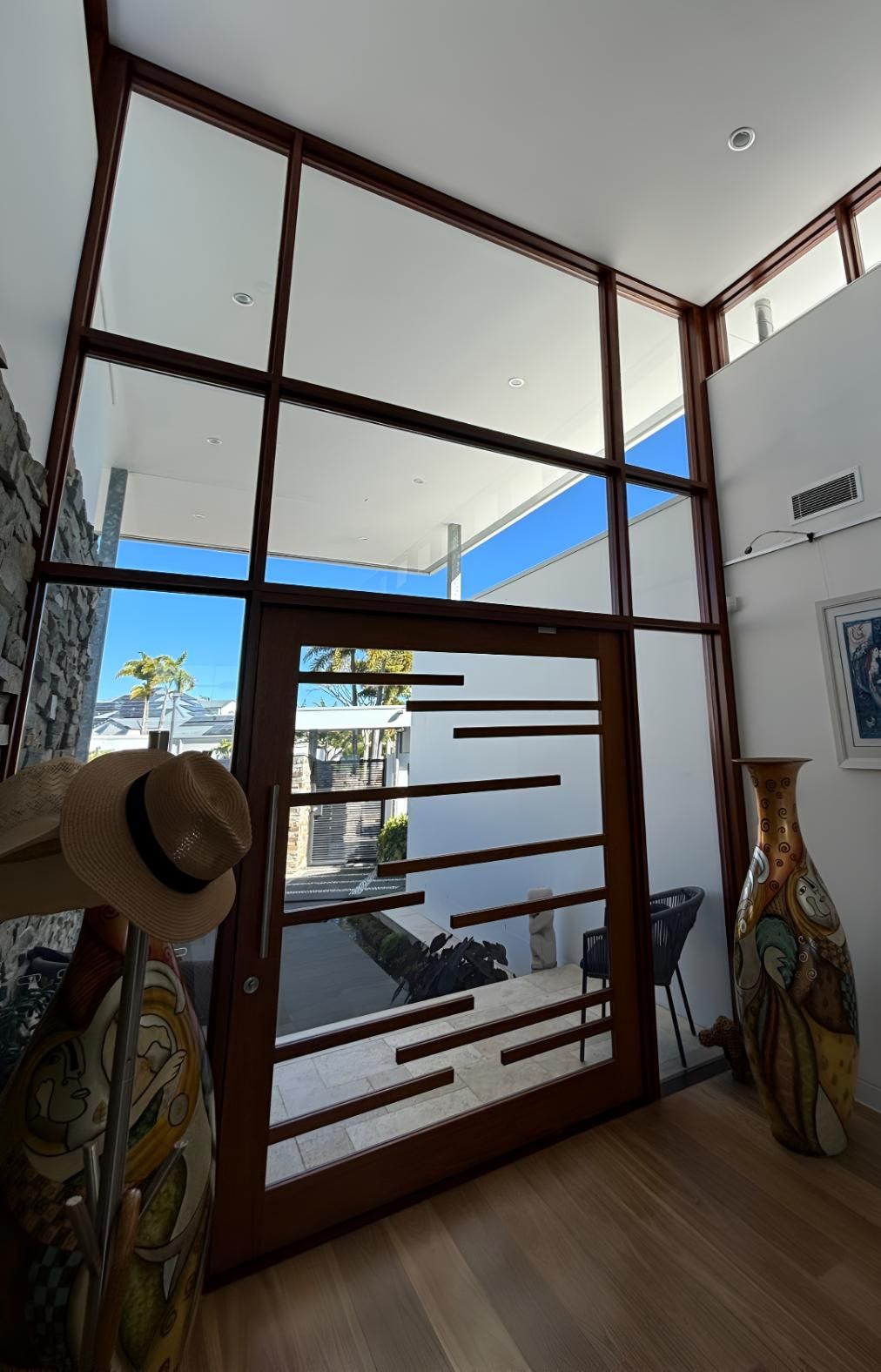Hat is Hanging on a Hook in Front of a Large Glass Door — Supercare Gold Coast in Paradise Point, QLD