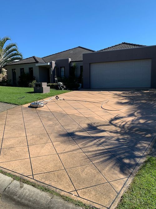A Pressure Cleaner Being Used To Clean A Driveway — Supercare Gold Coast in Miami, QLD