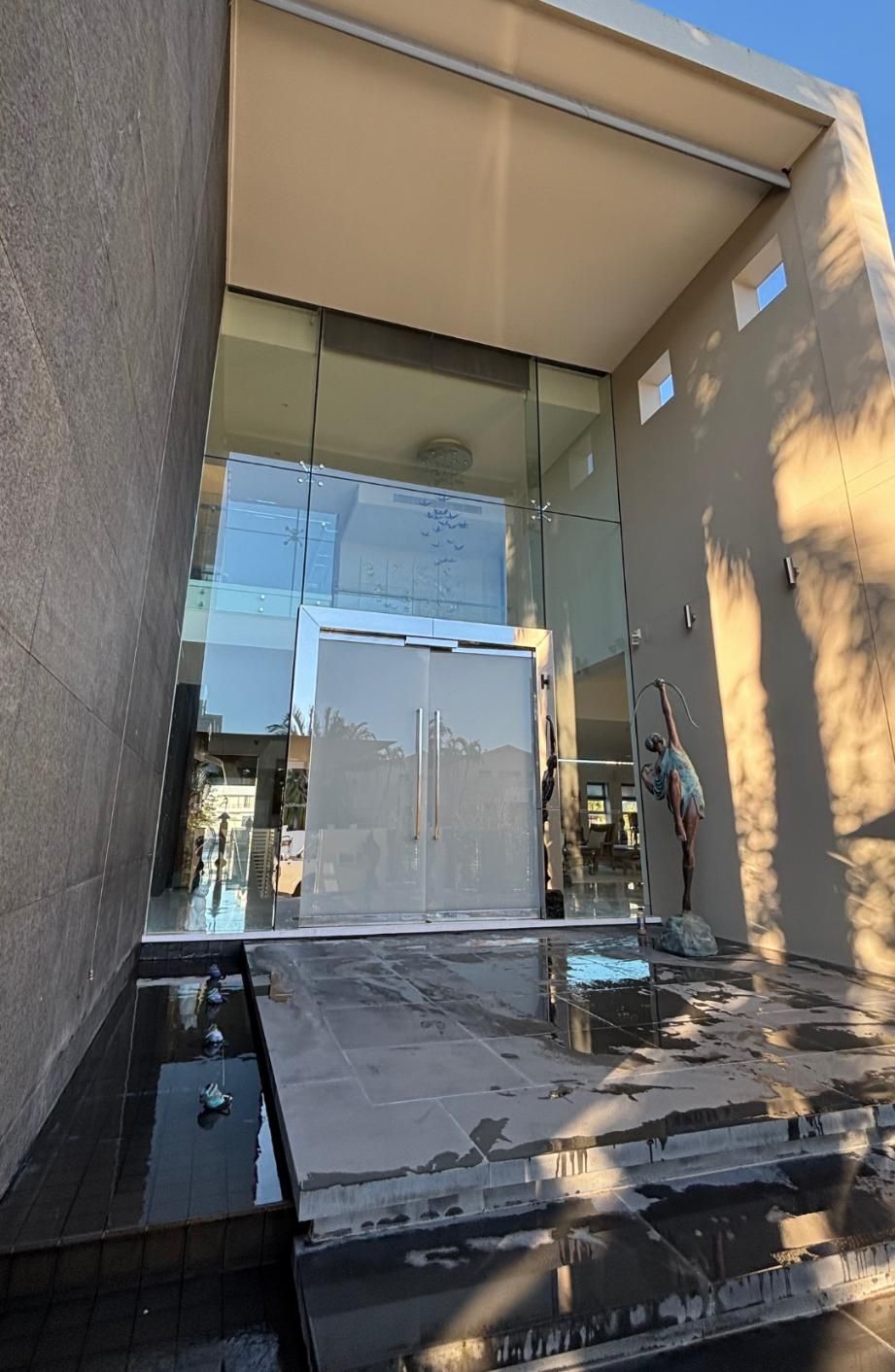 Man is Cleaning a Glass Door in a Building — Supercare Gold Coast in Miami, QLD