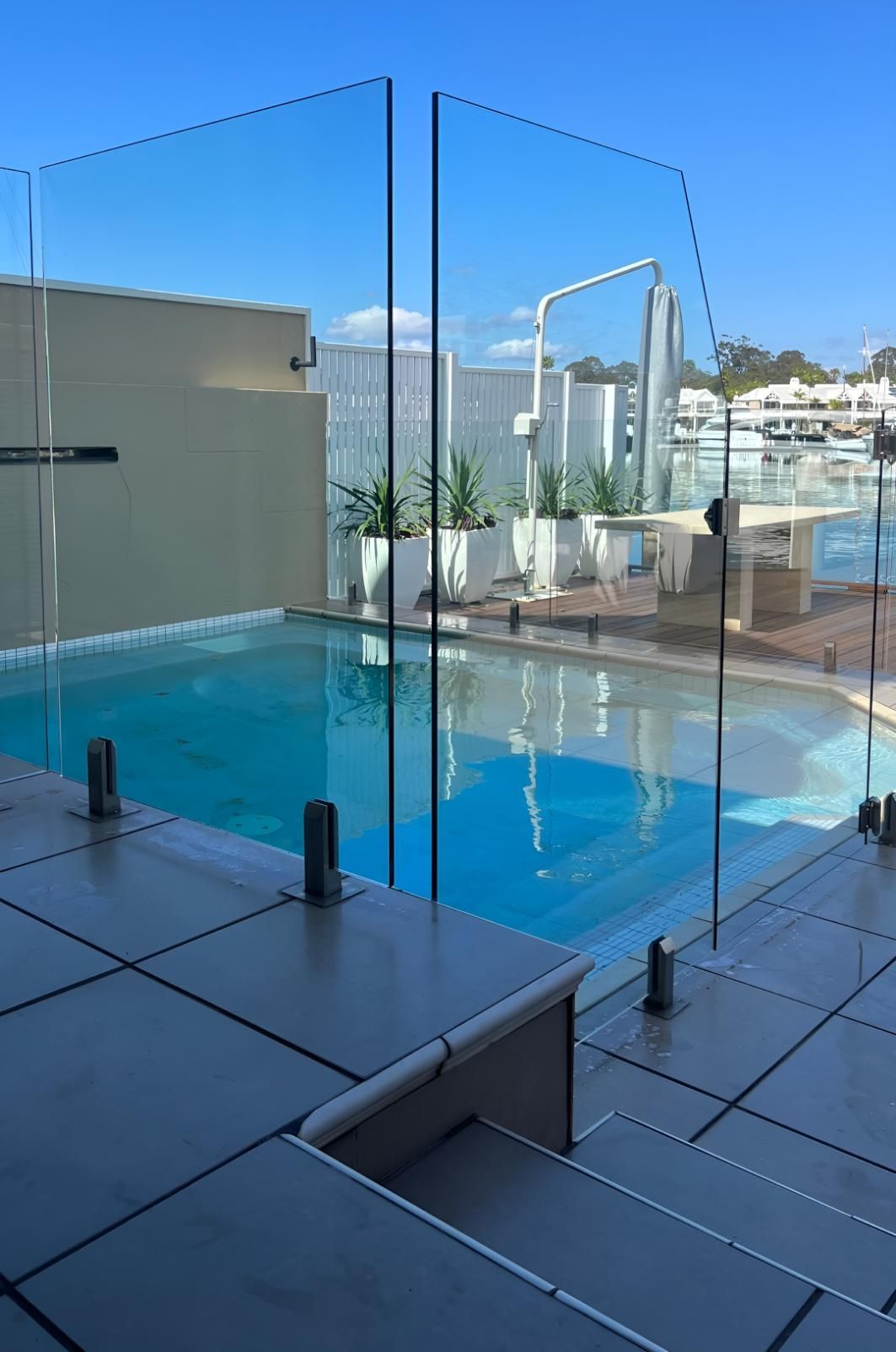 Large Swimming Pool With a Glass Fence Around It — Supercare Gold Coast in Palm Beach, QLD