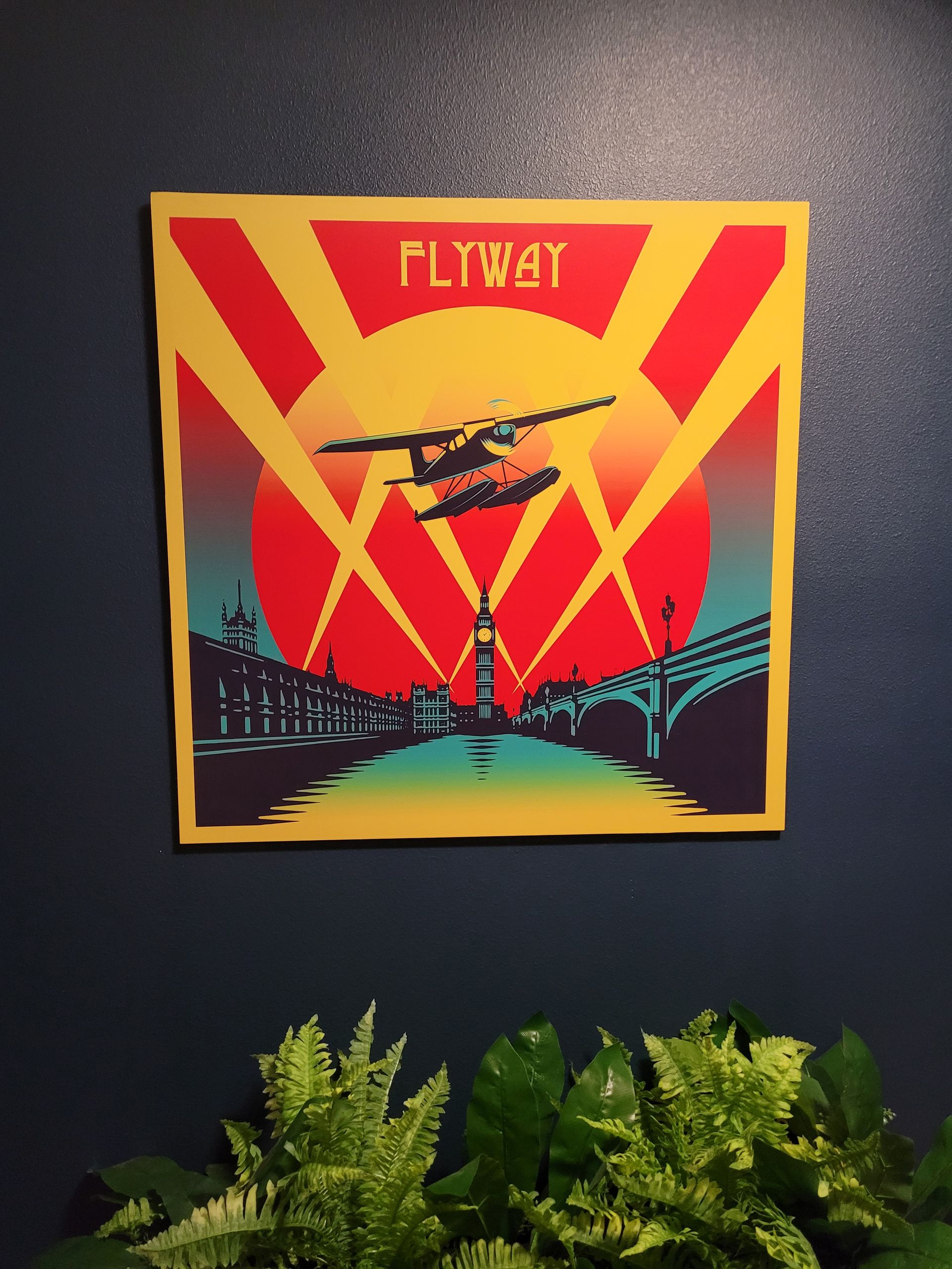 Poster of a seaplane flying over a city at sunset