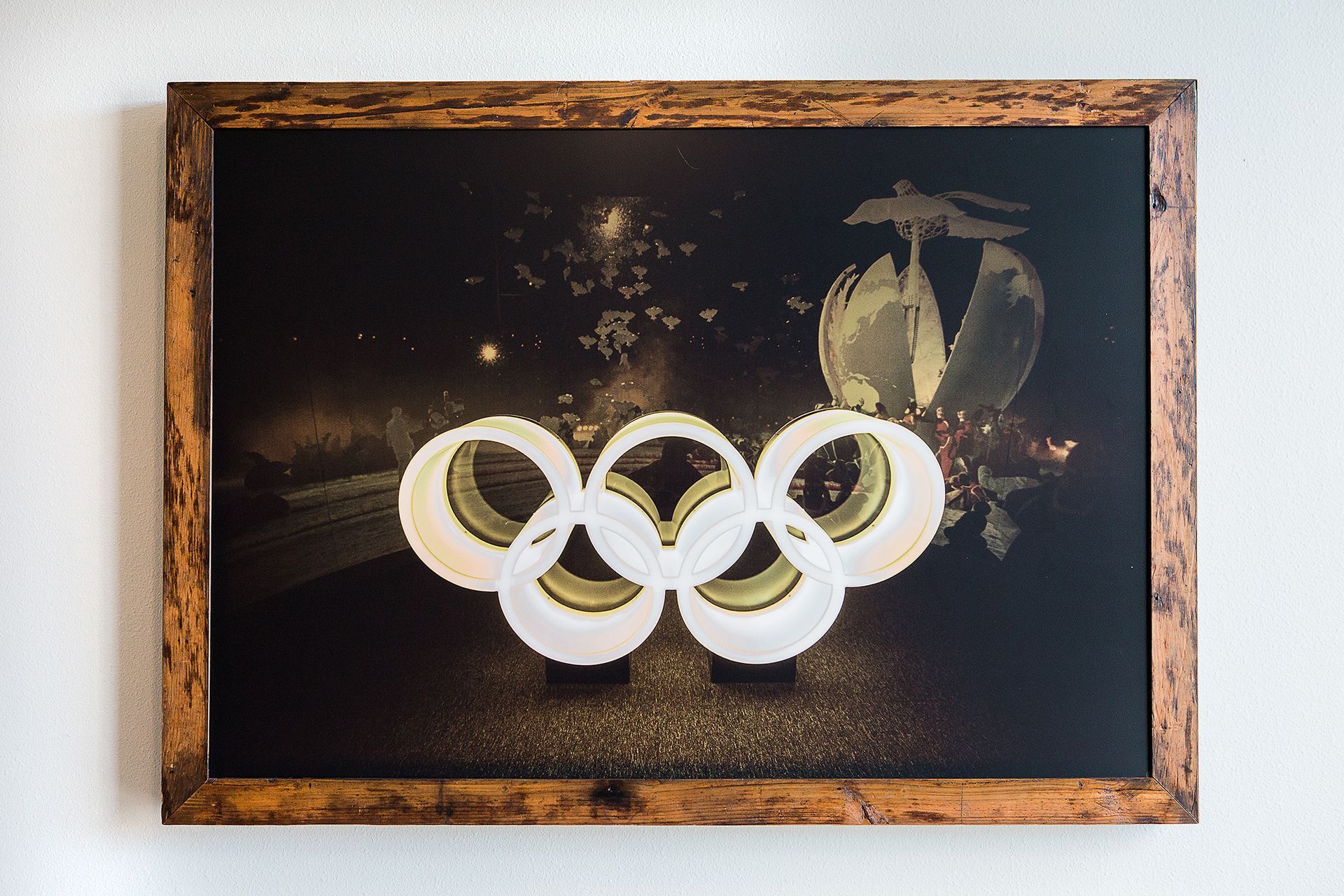 Framed artwork with olympic rings on a black background