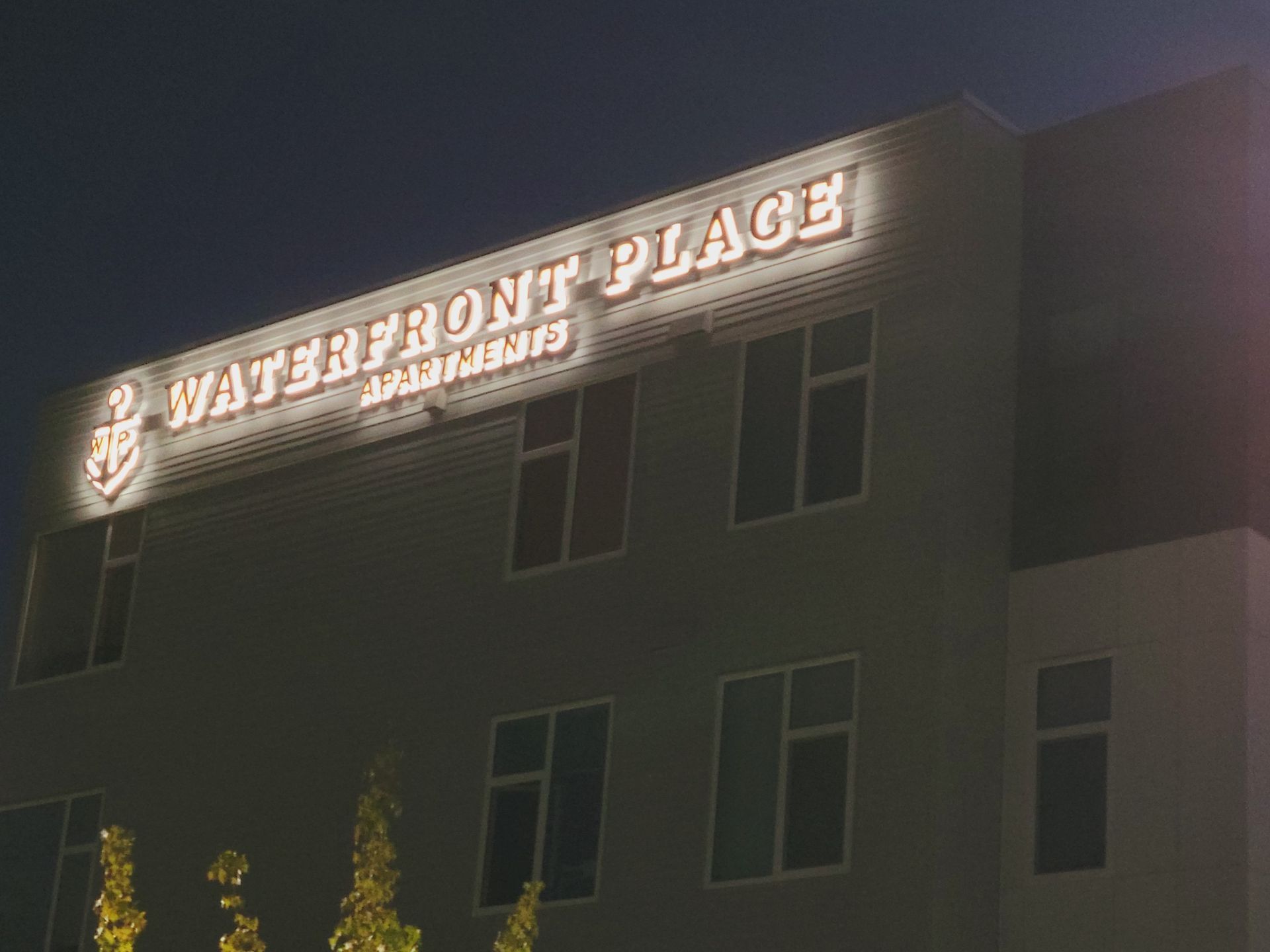 Waterfront place apartments building sign lit up at night