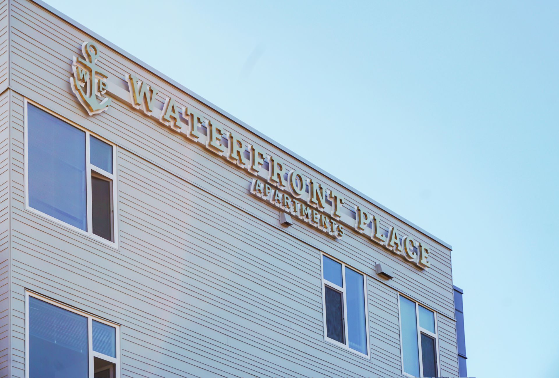 Building sign reading waterfront place at harbor's edge