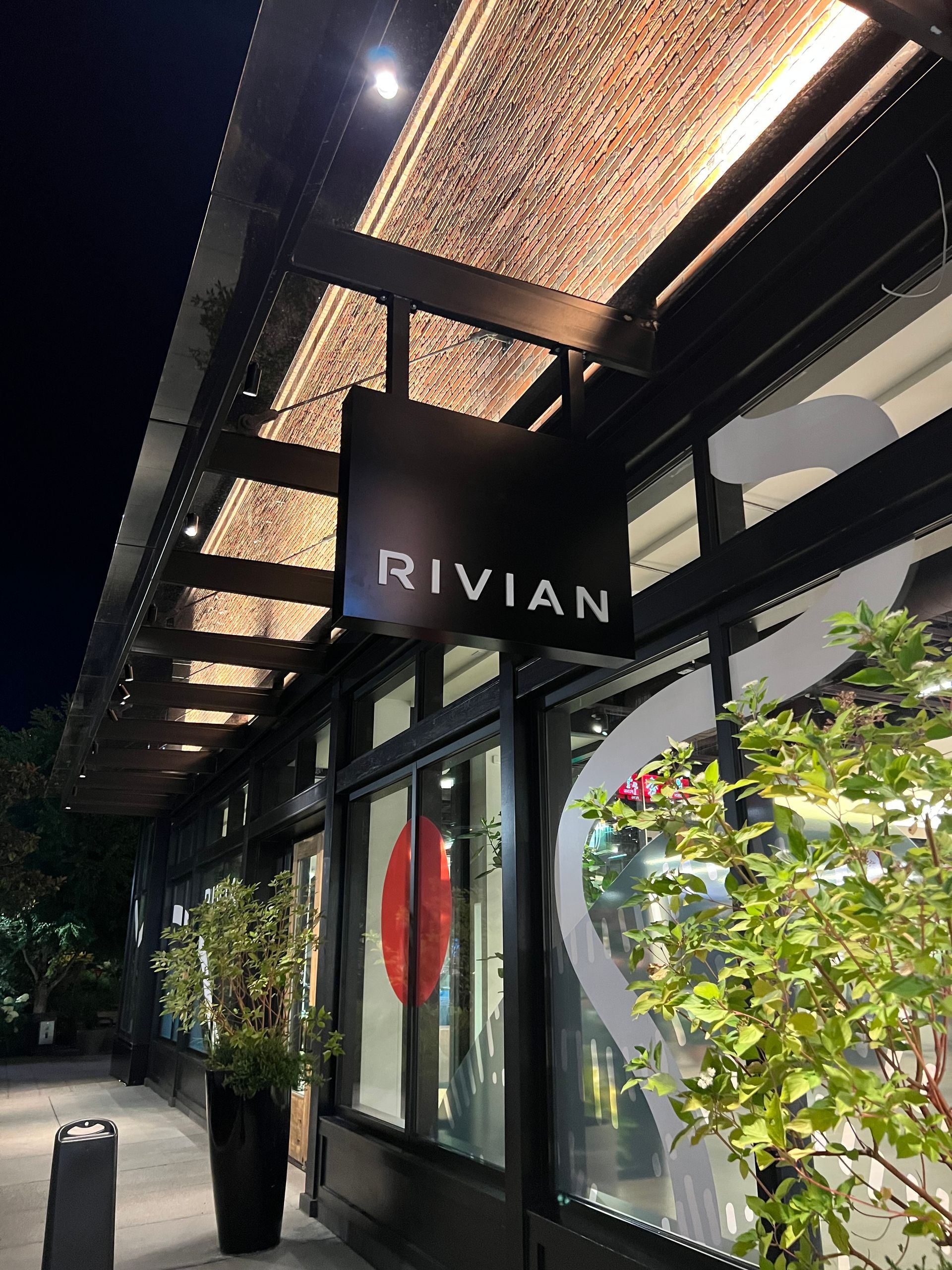 Rivian storefront with black sign