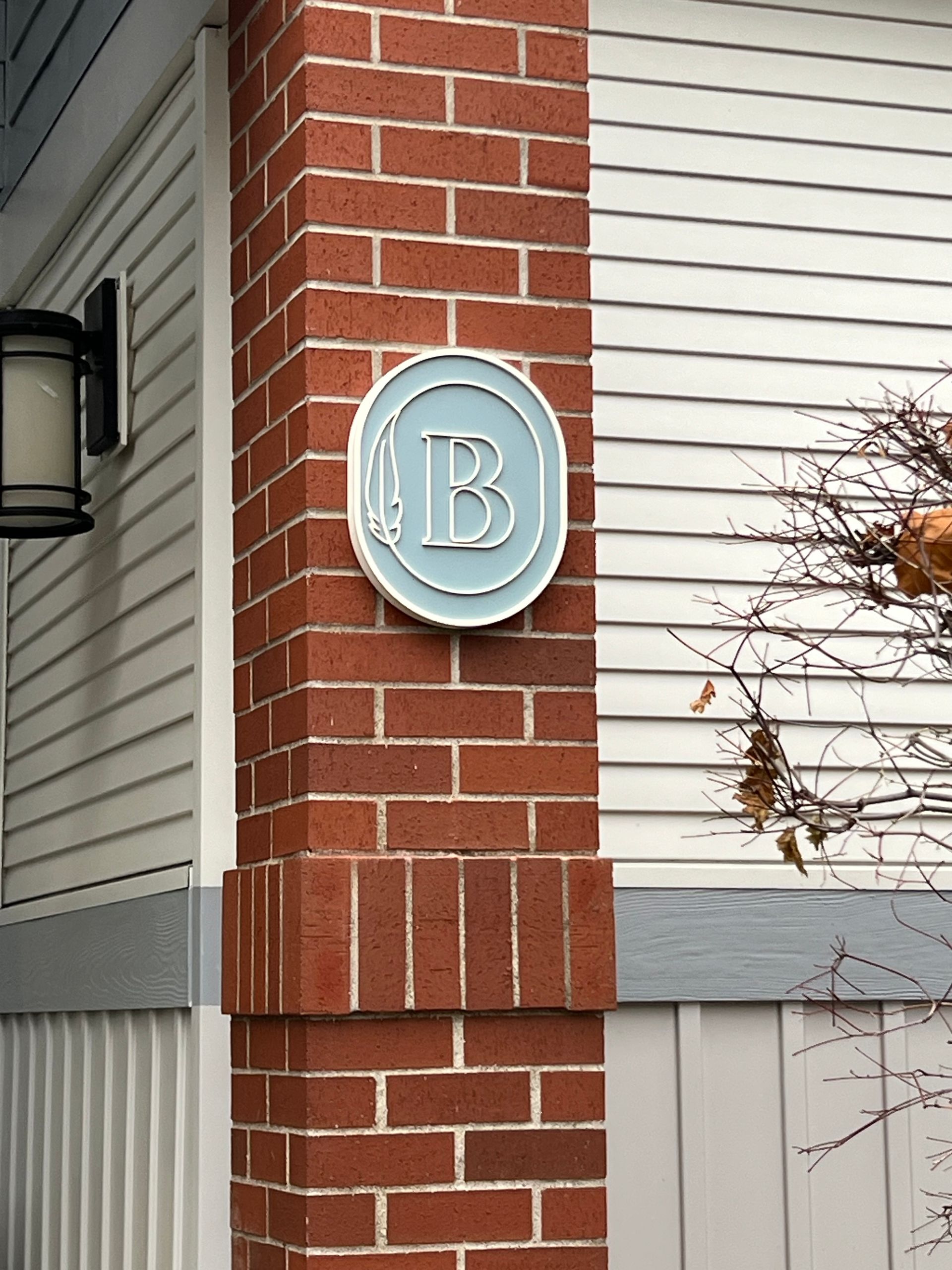 Brick pillar with a circular sign