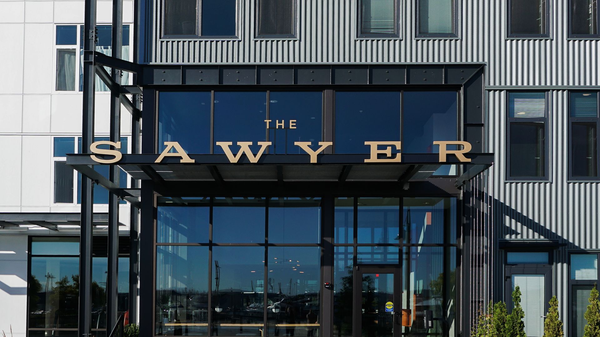 Building entrance with a glass entryway and a metal canopy