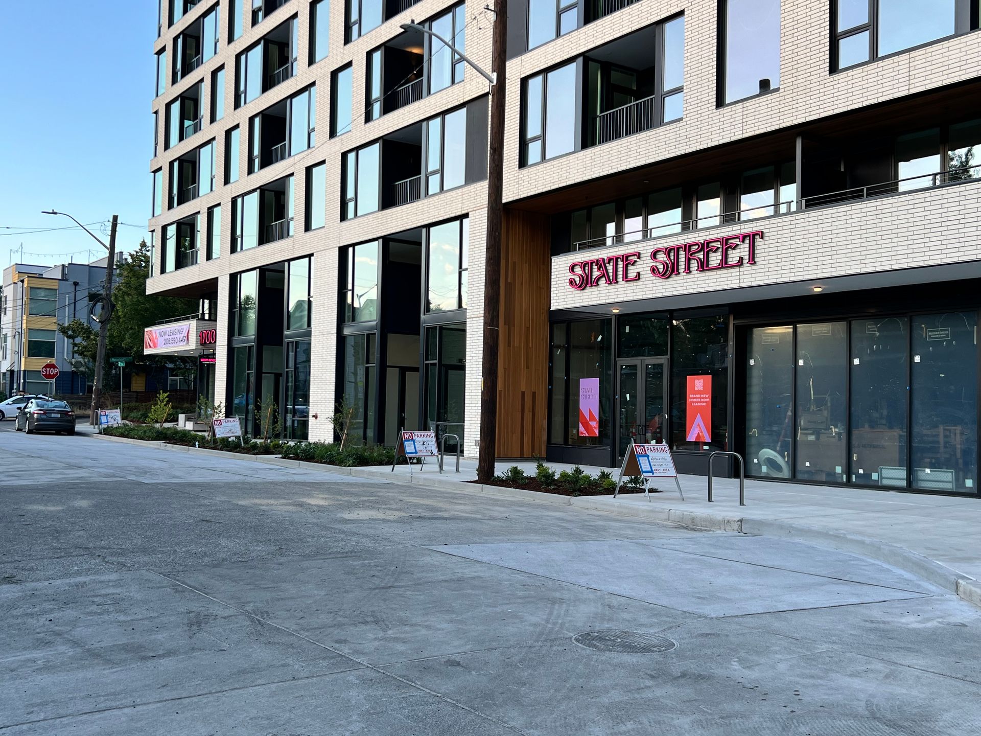 Street view of a modern building with retail spaces