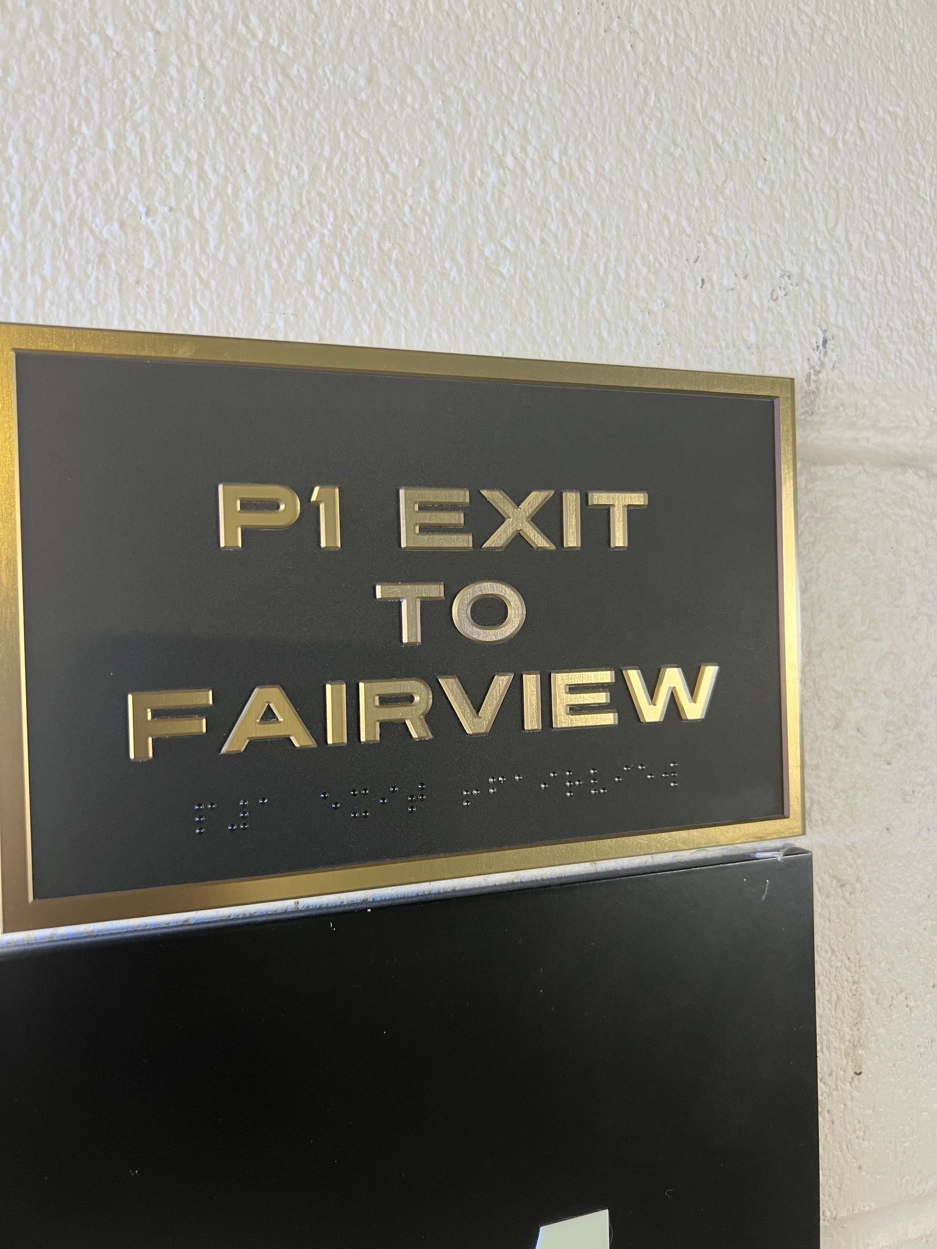 Black sign with gold lettering and trim