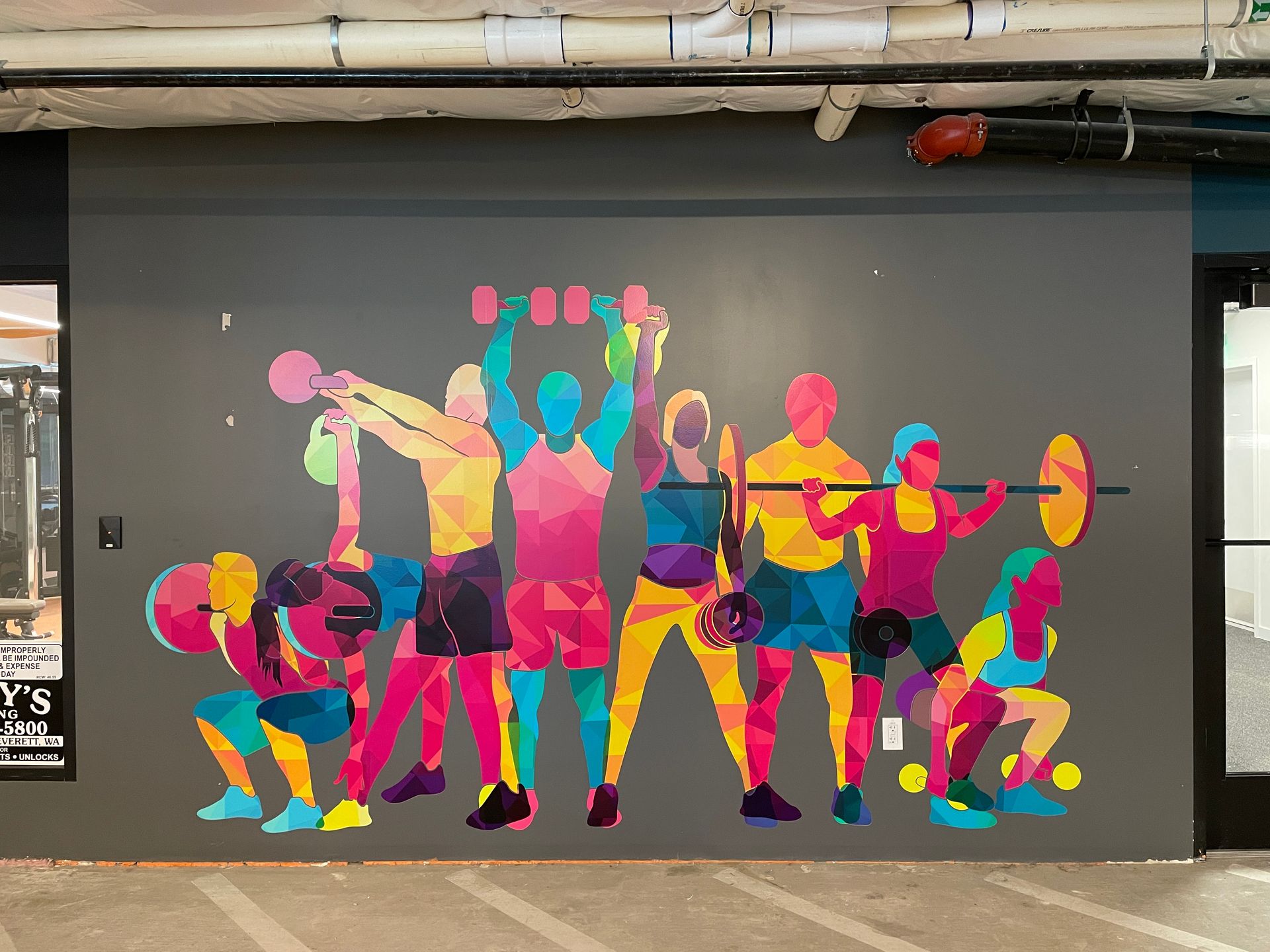 Colorful mural of weightlifters i various poses against a gray wall.