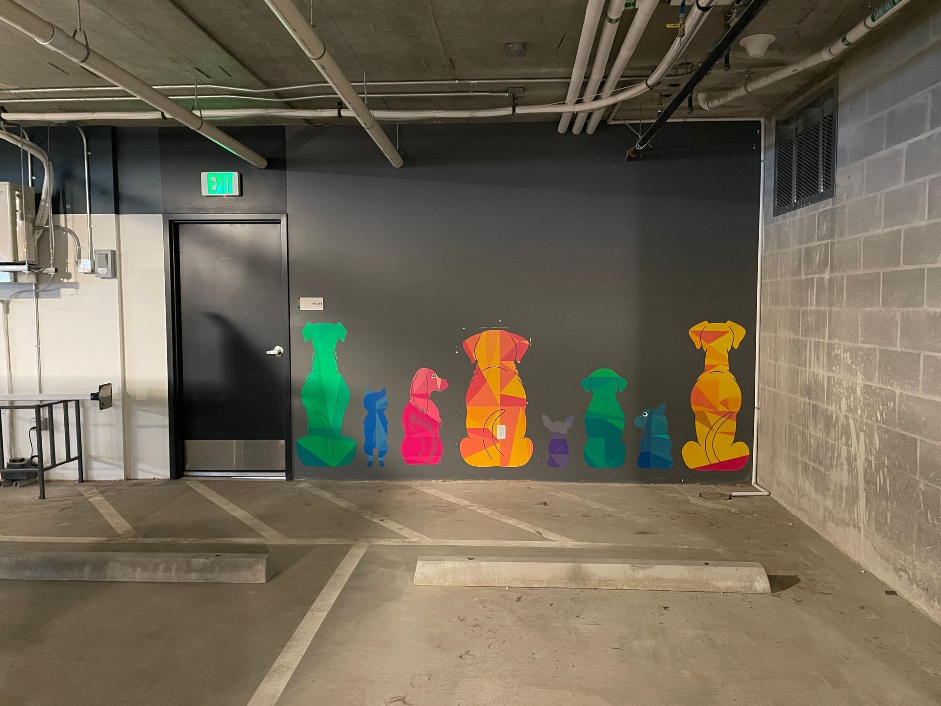 Parking garage wall with colorful dog silhouettes