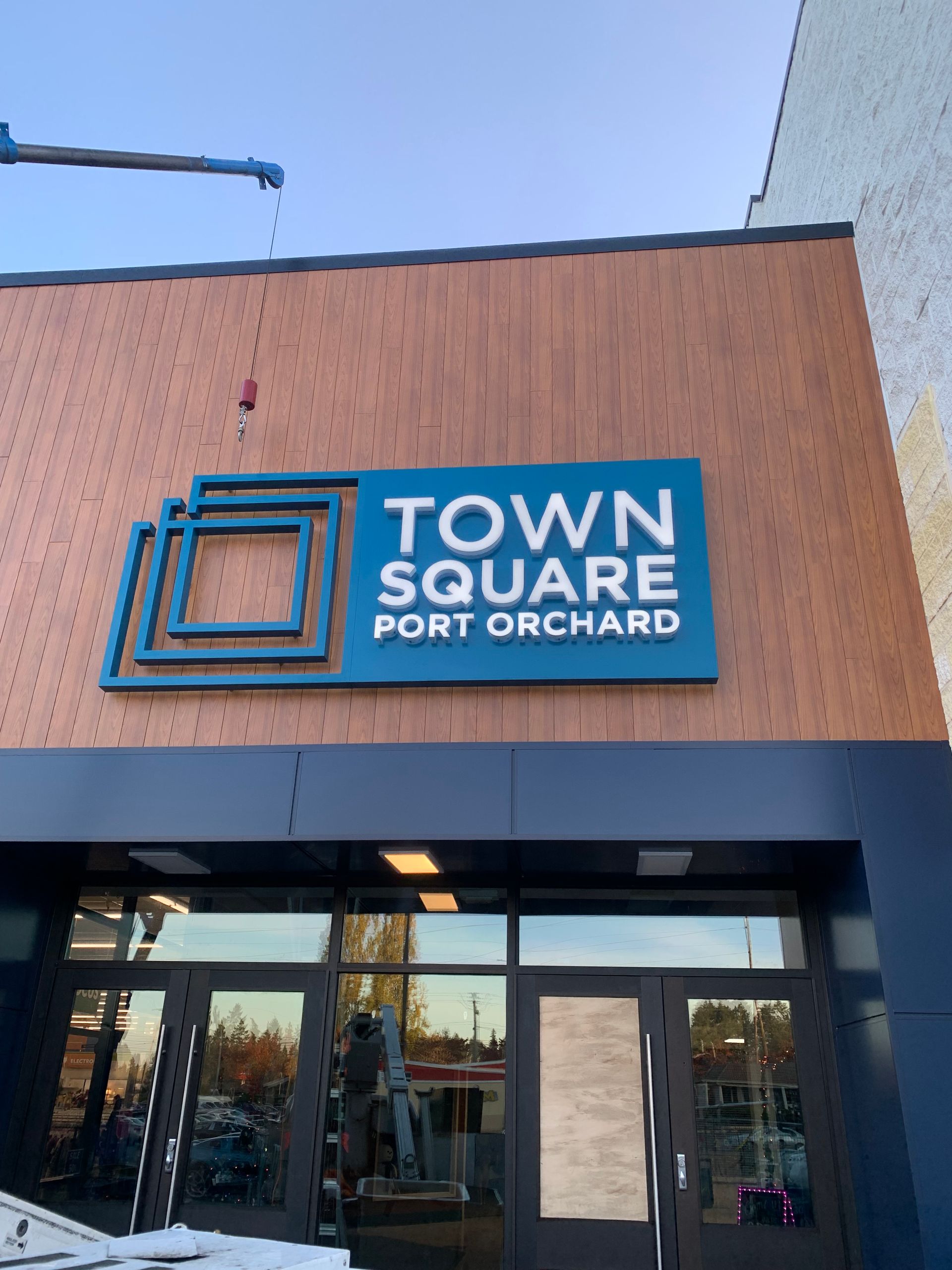 Town square port orchard sign above entrance, teal and white lettering