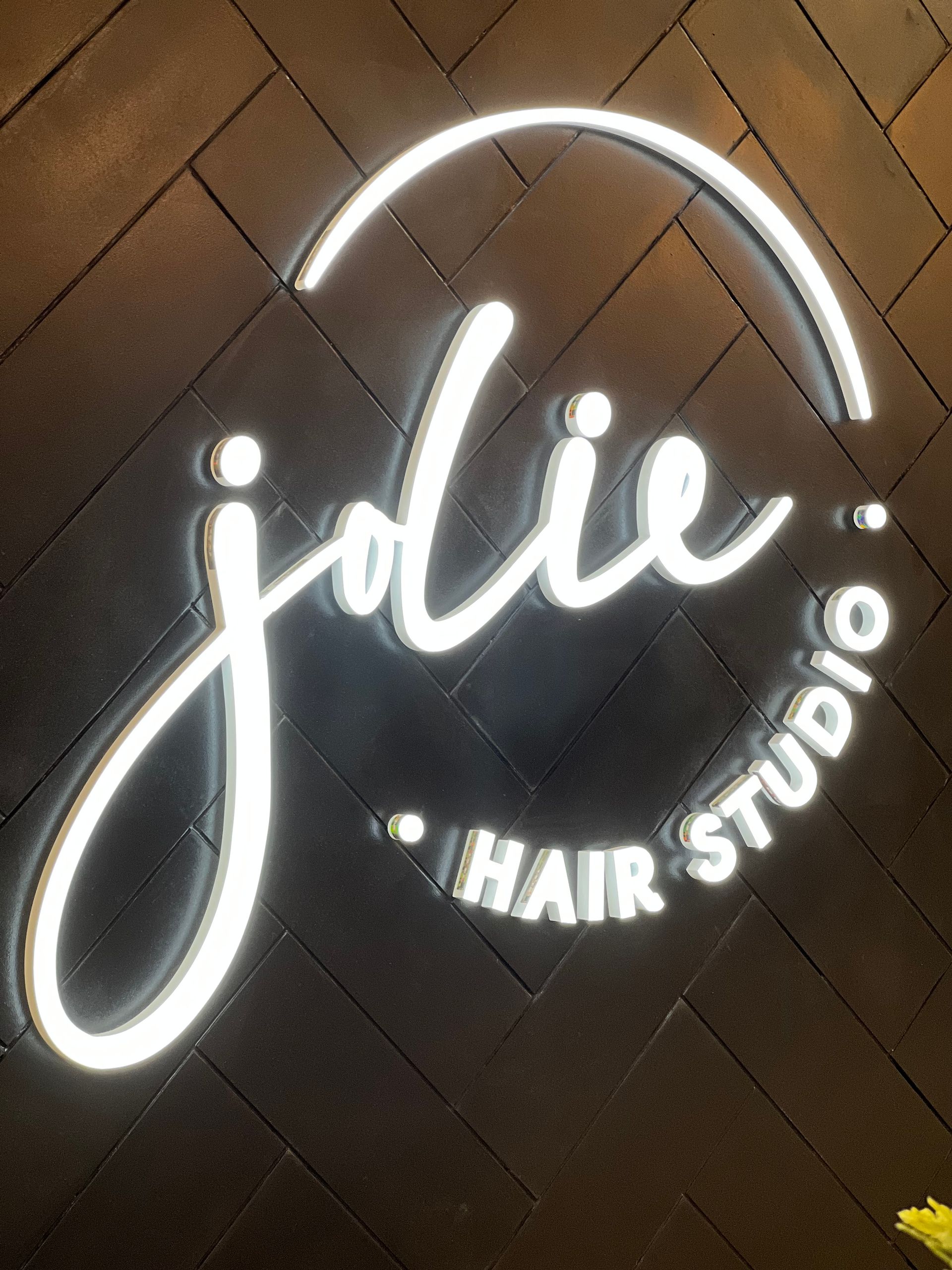 Glowing logo on a dark brick wall