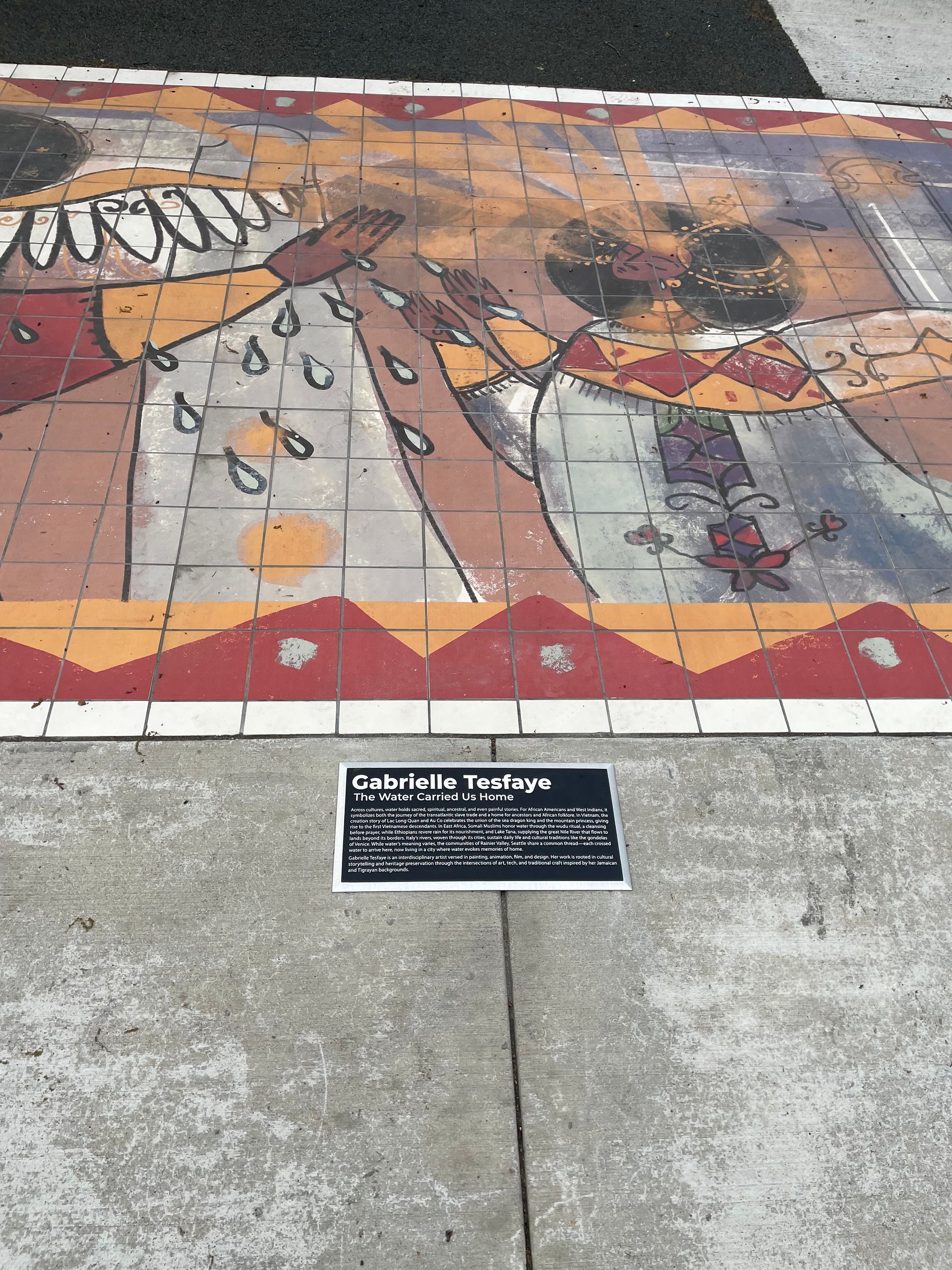 Colorful sidewalk mural with a sign