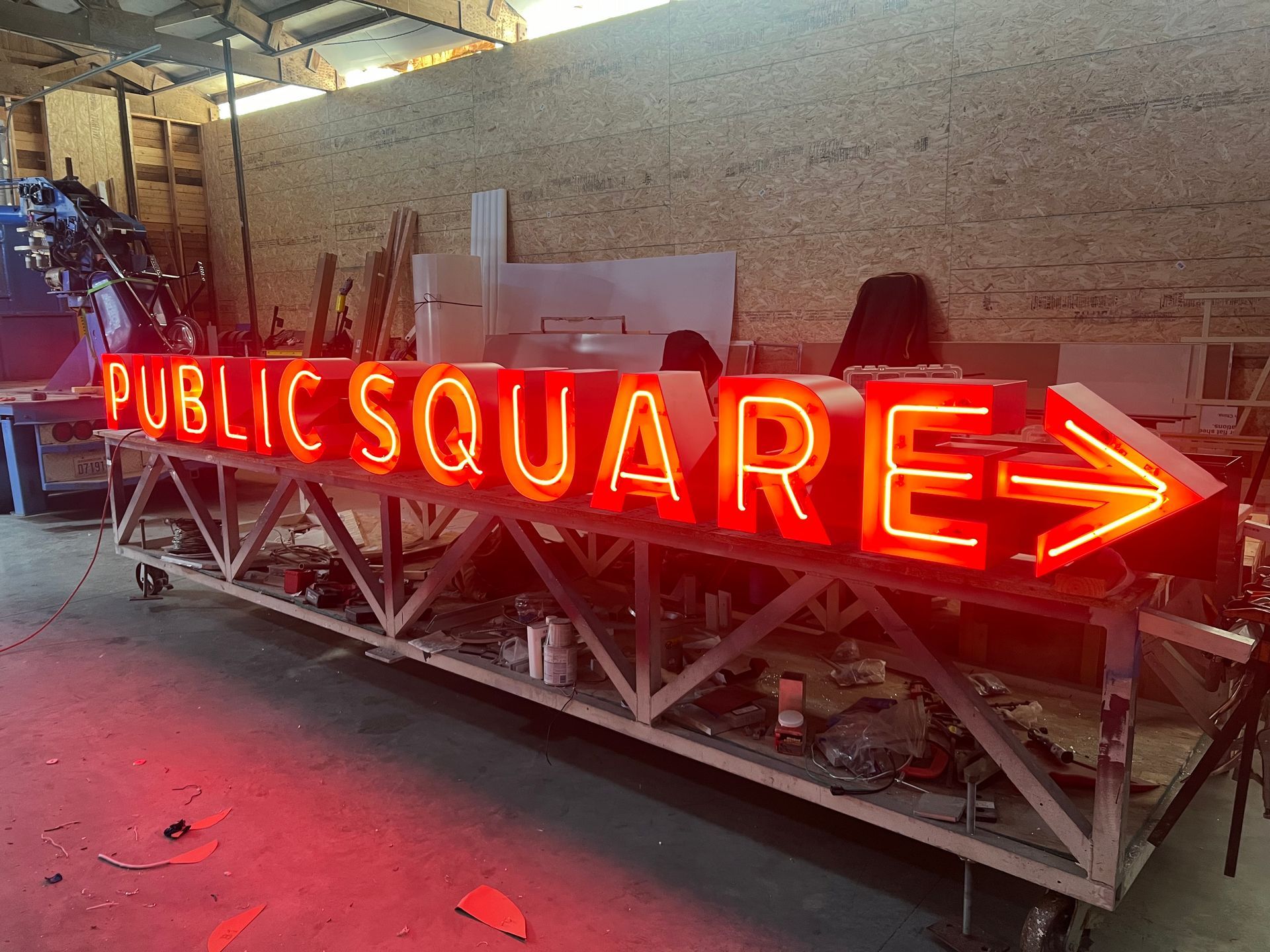 A long, lit-up red neon sign