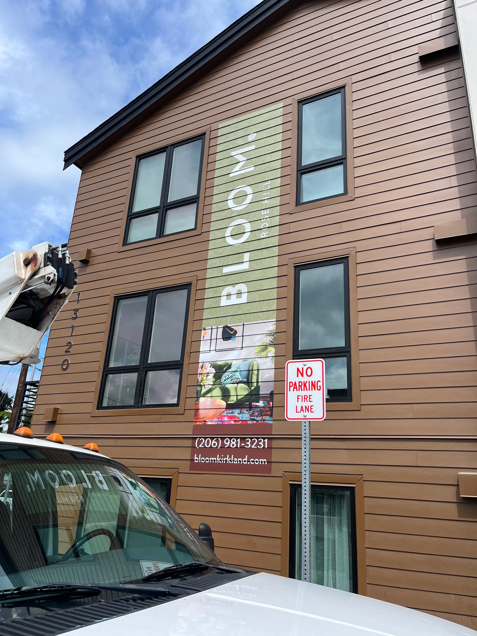 Brown building with banner and sign