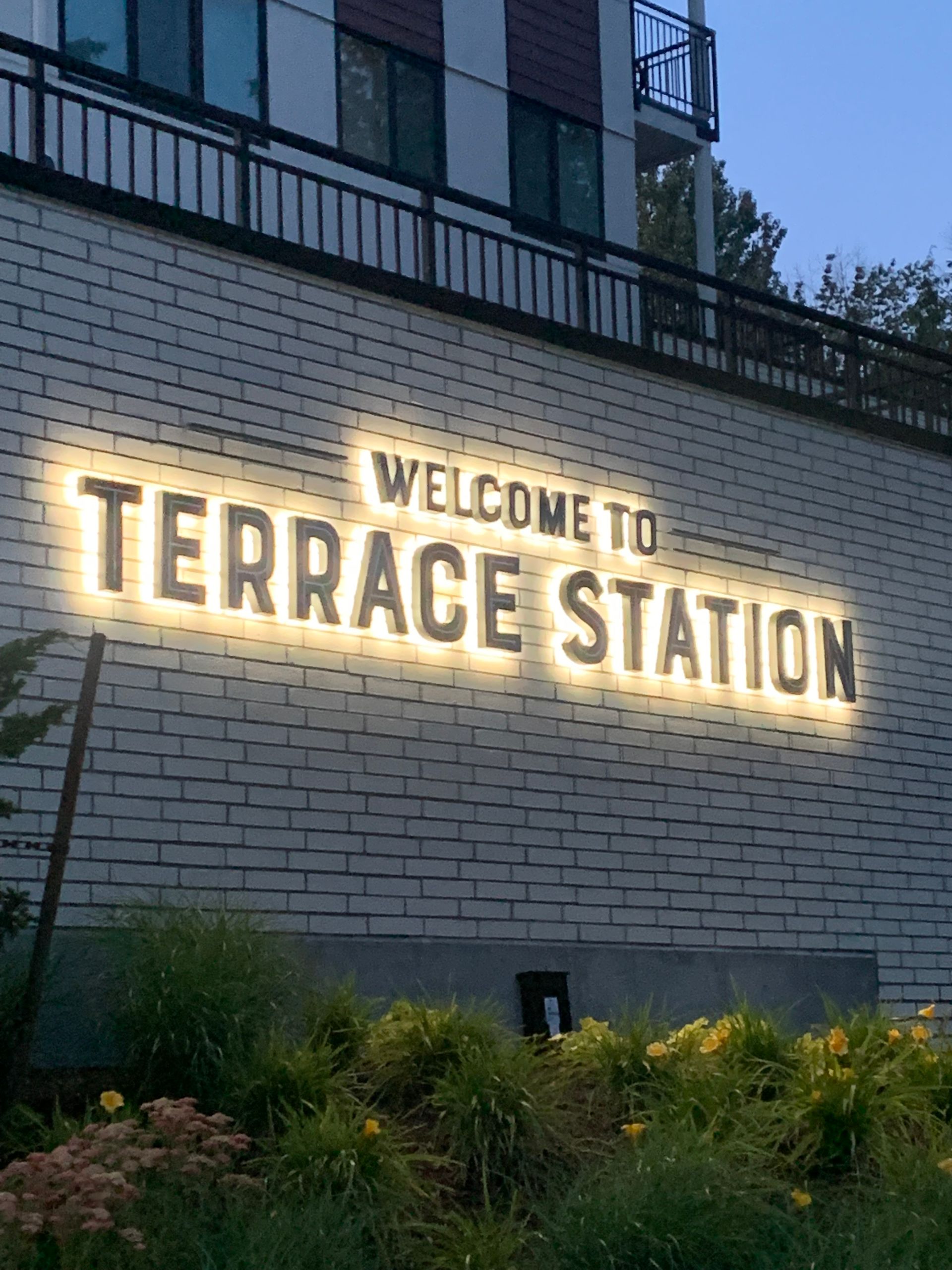 Terrace station west building entrance with dark signage and large windows