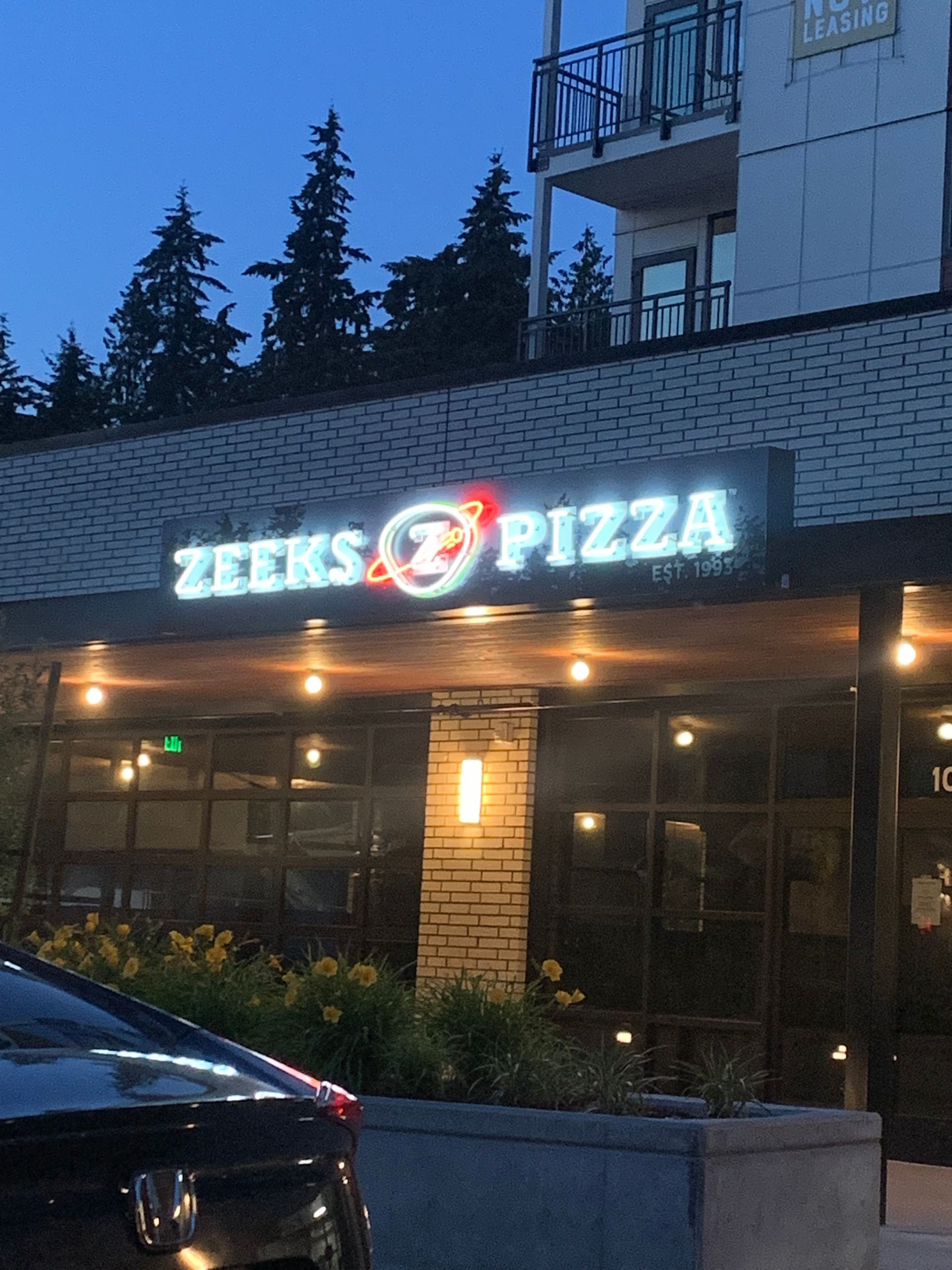 Zeeks pizza restaurant exterior with illuminated sign