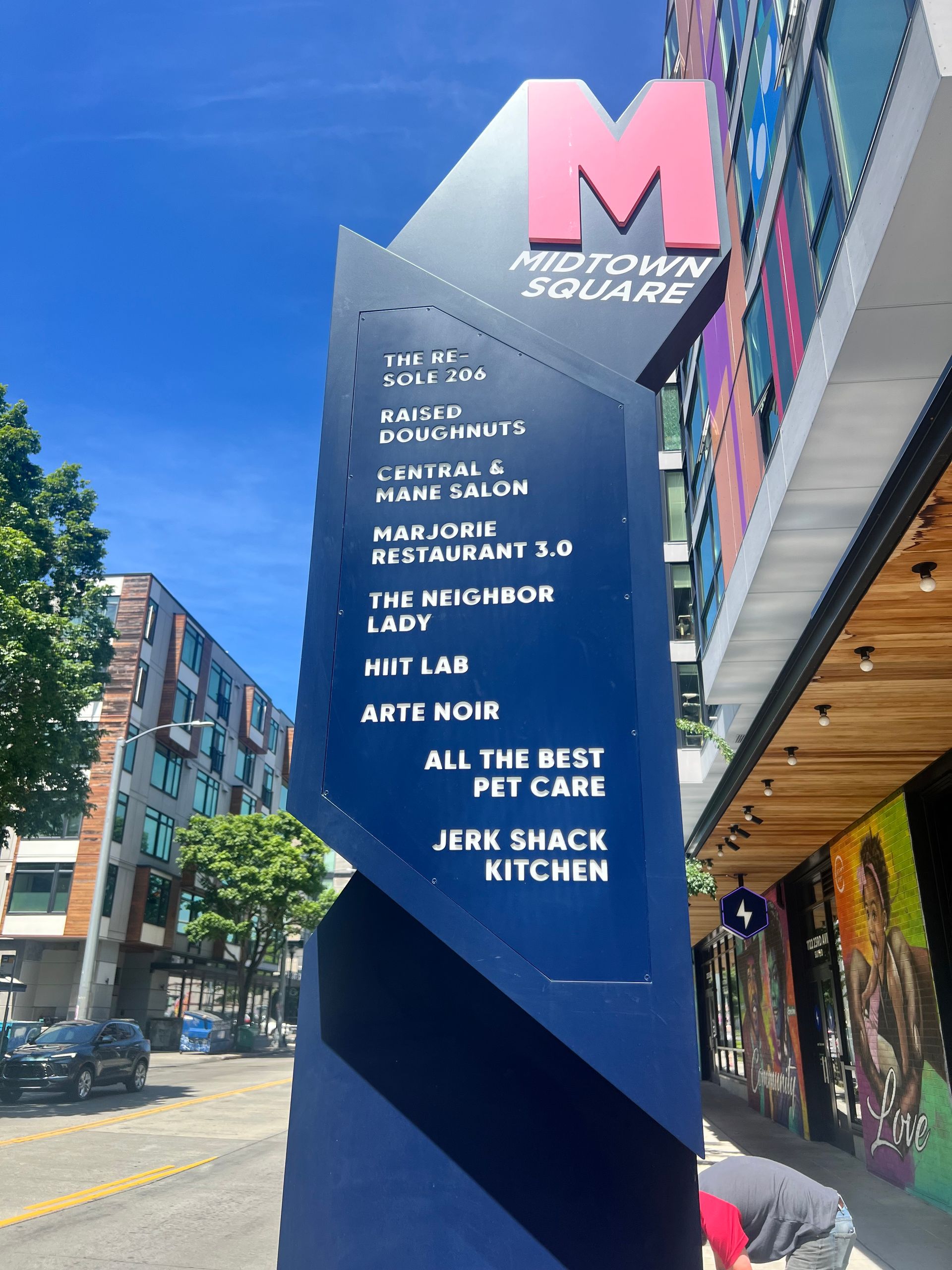 Sign for midtown square with a list of businesses