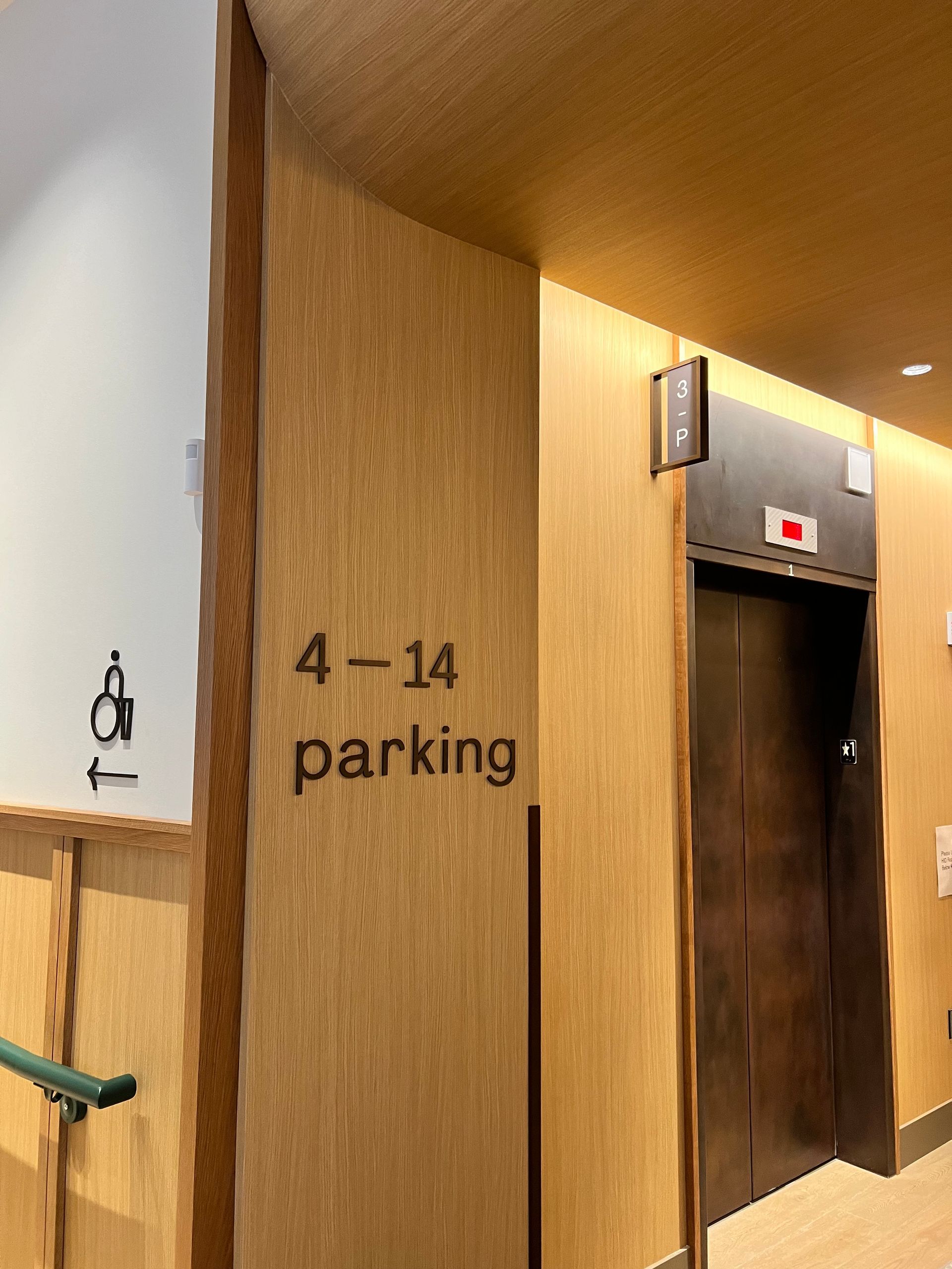 Elevator entrance and parking sign
