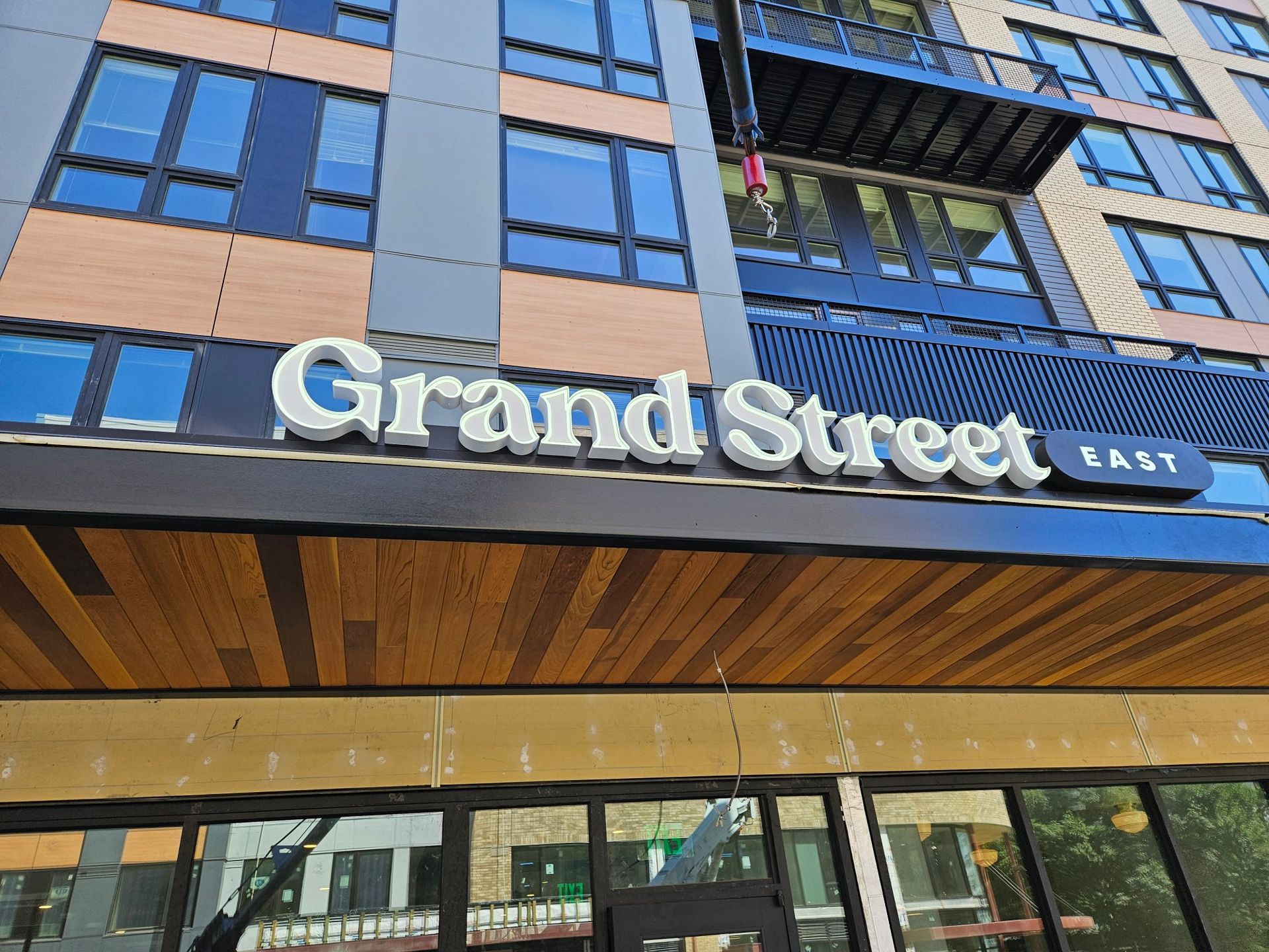 Sign on a modern building facade with blue