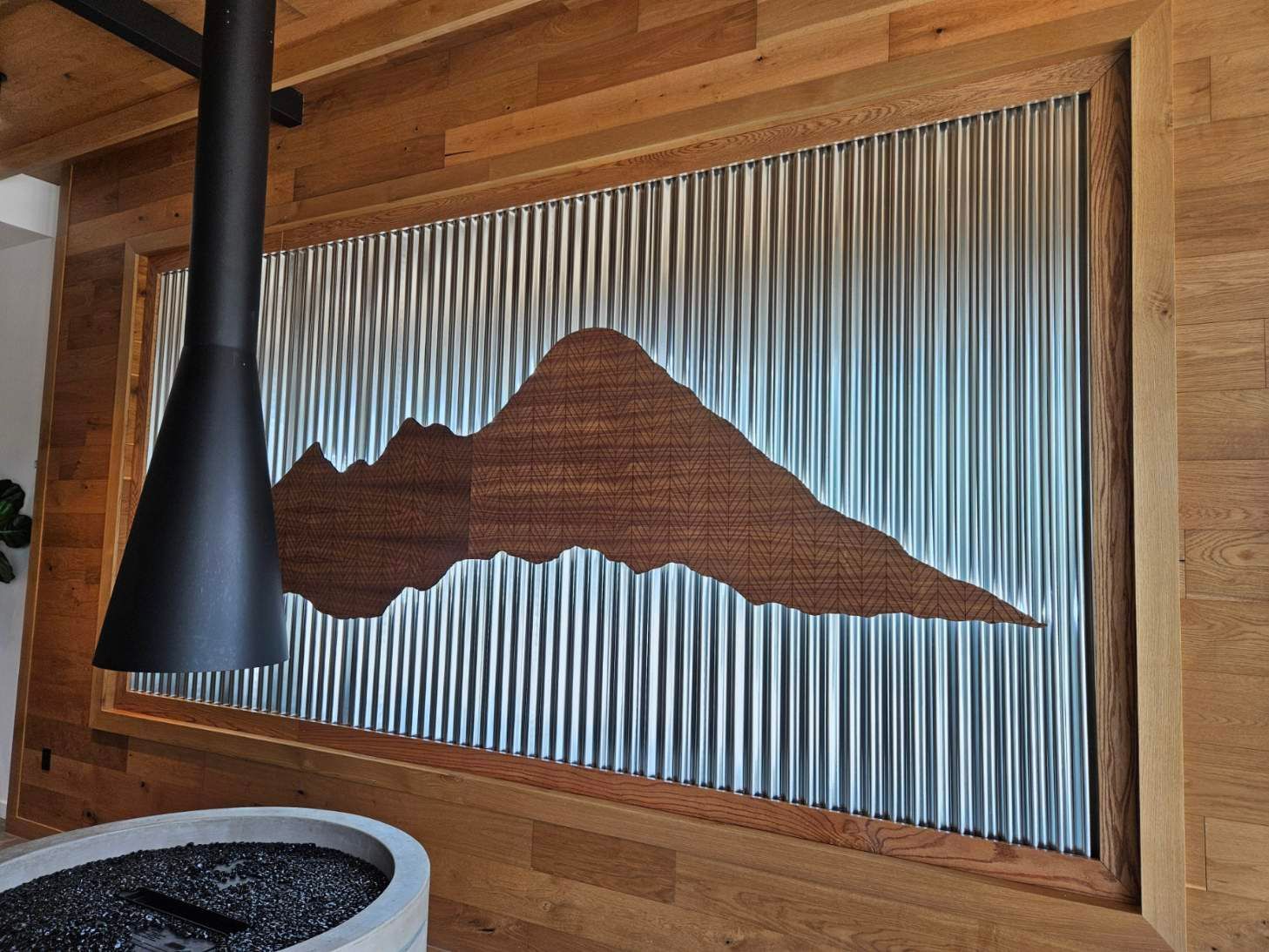 Wooden wall with metal corrugated panel and a mountain silhouette
