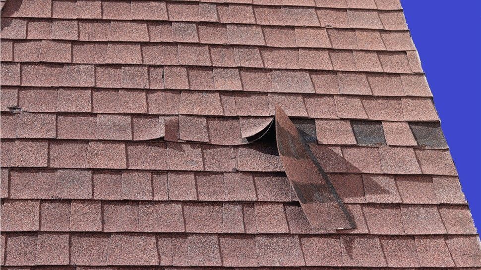 Missing shingles on roof after wind damage