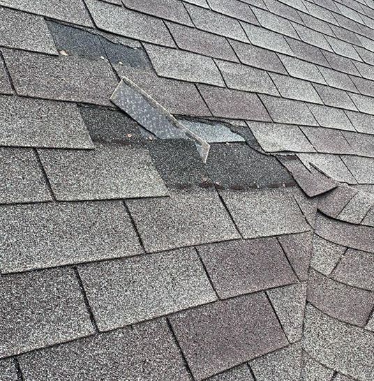 Missing shingles on roof after wind damage