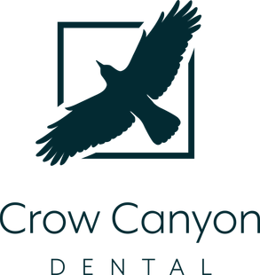 The logo for crow canyon dental has a bird on it.