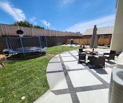 Long hallway with shiny gray floor, boxes, door, and two people standing.
