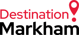 The logo for destination markham has a red pin on it.