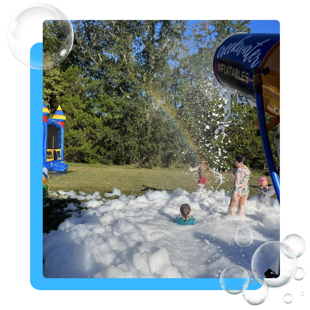 A group of children are playing in a field of soap bubbles.