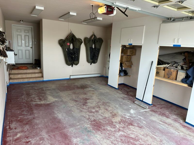 An empty garage with a mop on the floor