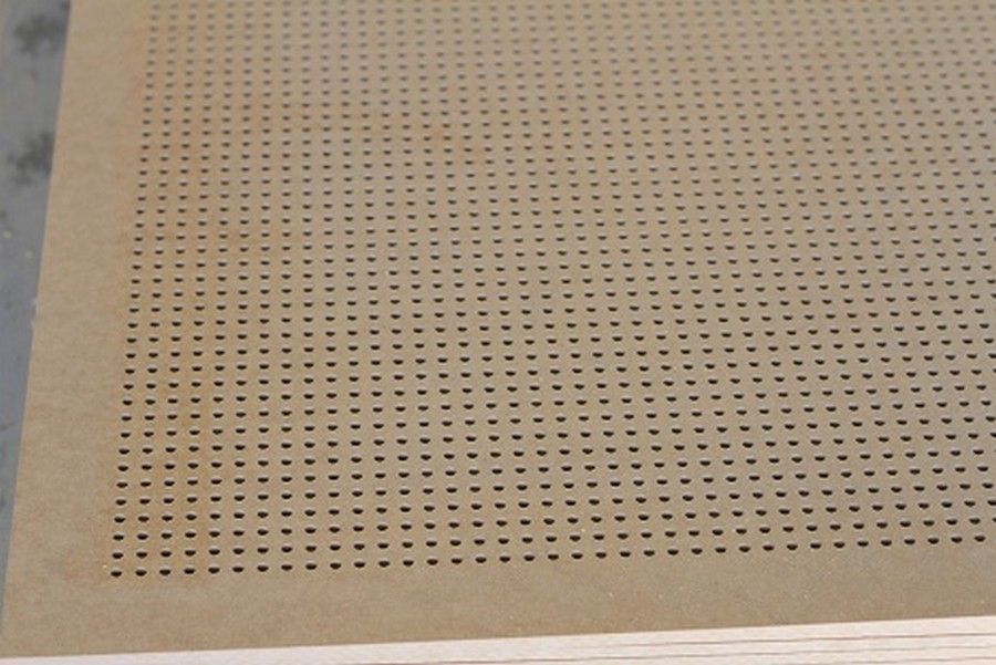 A close up of a piece of wood with holes in it.