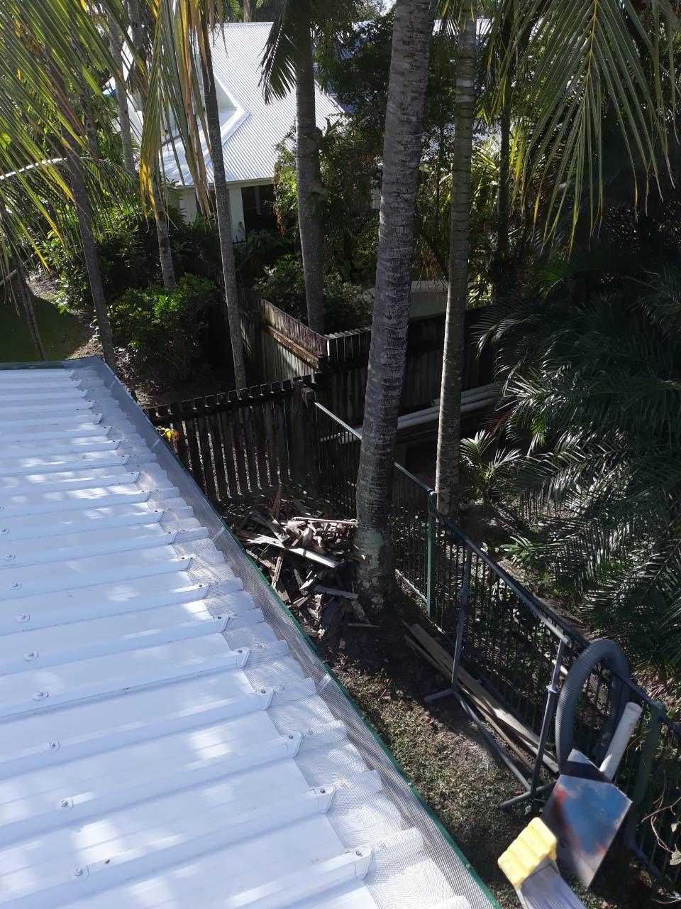 View from A Roof of A Yard with A Fence, Trees, and A House in The Background — All-Clear Gutter Guard NQ in Julatten, QLD