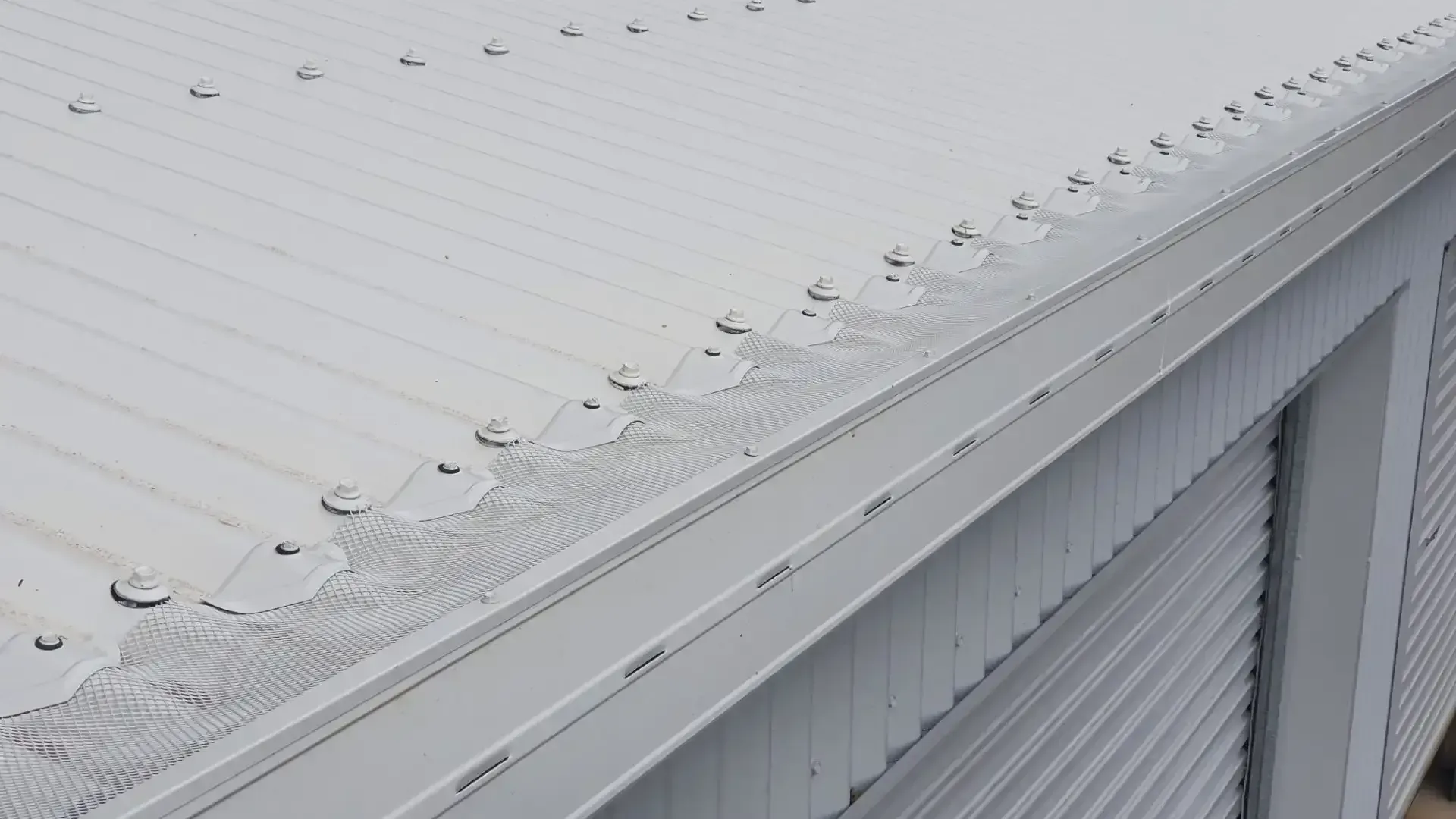 A White Roof With a Gutter on the Side of a Building  — All-Clear Gutter Guard NQ in Cairns, QLD