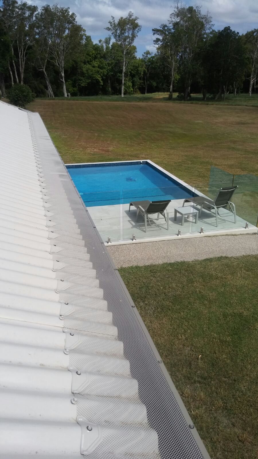 View of A Pool and Yard from A White Roof — All-Clear Gutter Guard NQ in Walkamin, QLD