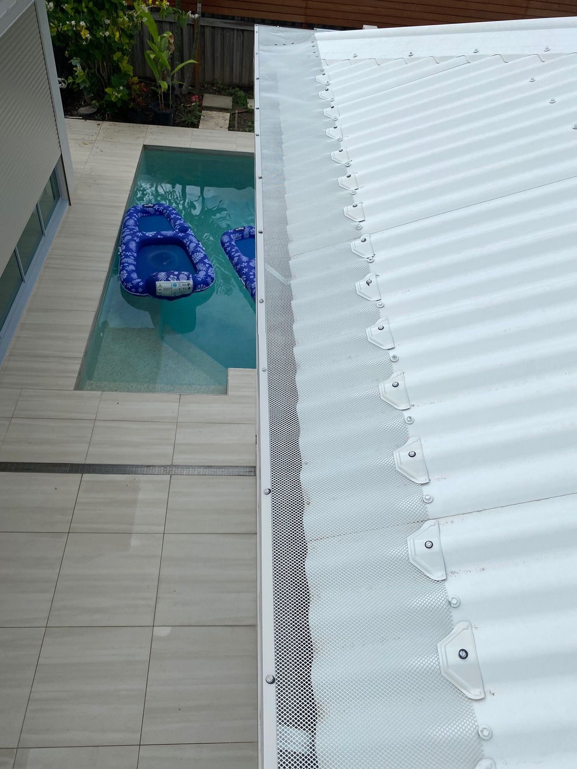 A white roof with a gutter and a pool in the background — All-Clear Gutter Guard NQ in Tablelands, QLD