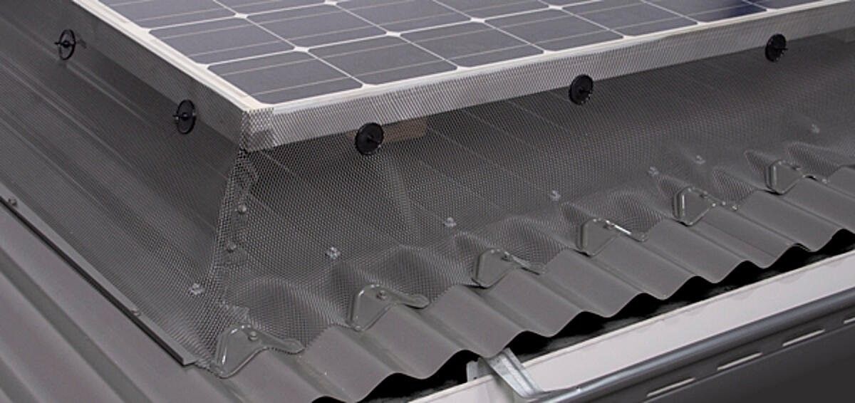 A solar panel is sitting on top of a metal roof  — All-Clear Gutter Guard NQ in Cairns, QLD