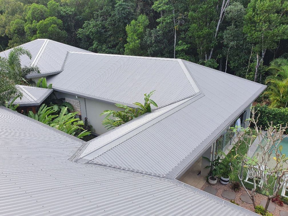 Gray Metal Roof of A House, Set in Lush Green Vegetation — All-Clear Gutter Guard NQ in Innisfail, QLD